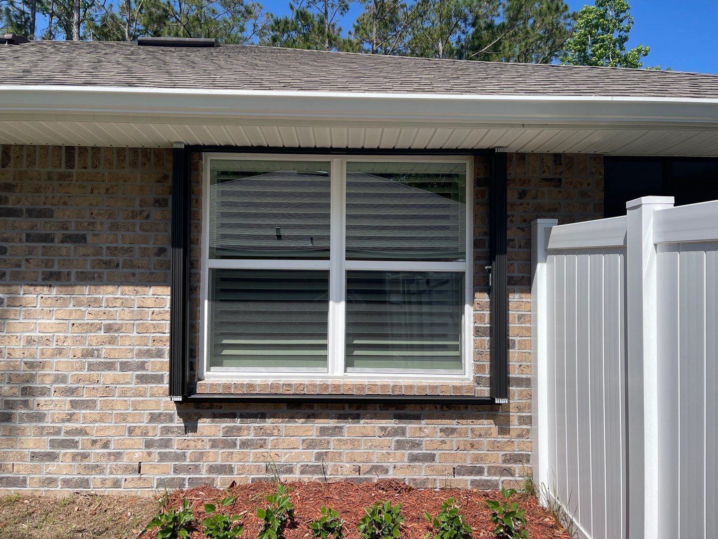 Bronze Accordions on brick home by Smart Guard Shutters