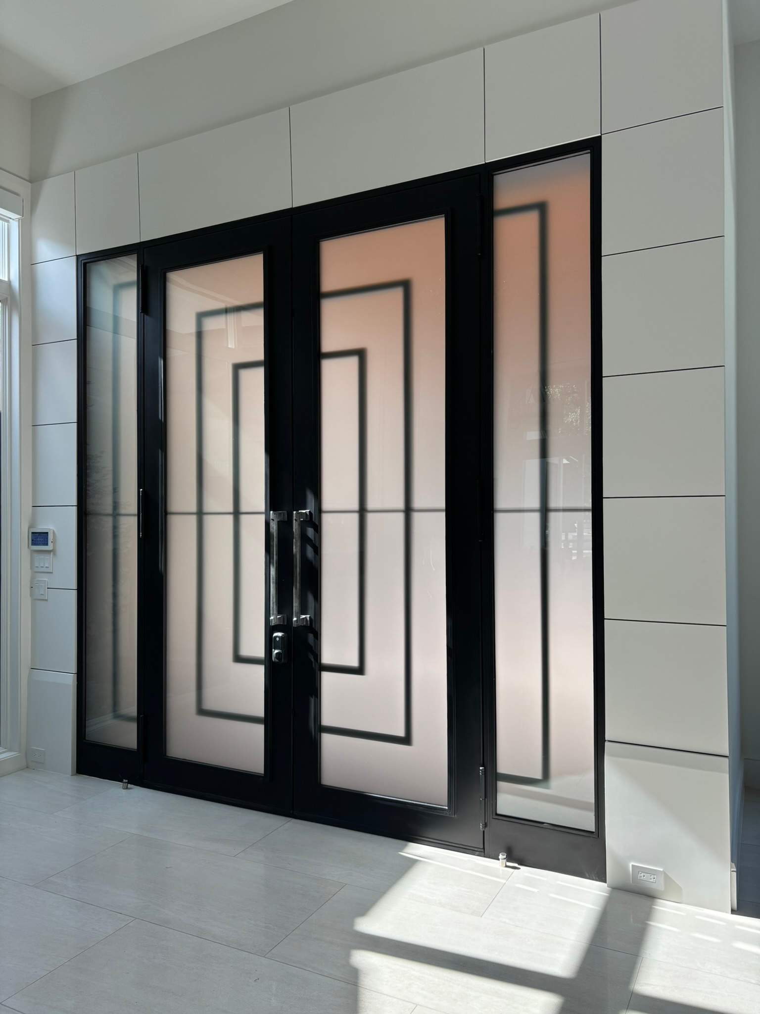 Modern Metal and Glass Entryway Installation with Custom Hardware Finishing in Dallas by Solara Custom Living