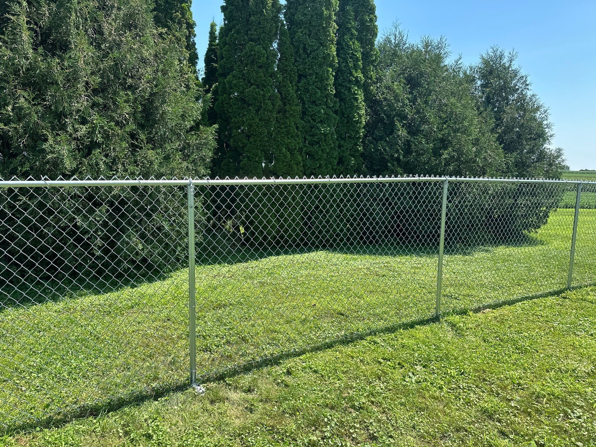 Residential Galvanized Chain Link Perimeter Fence Installation in New Hartford by Perfect Picket Fence and Stain