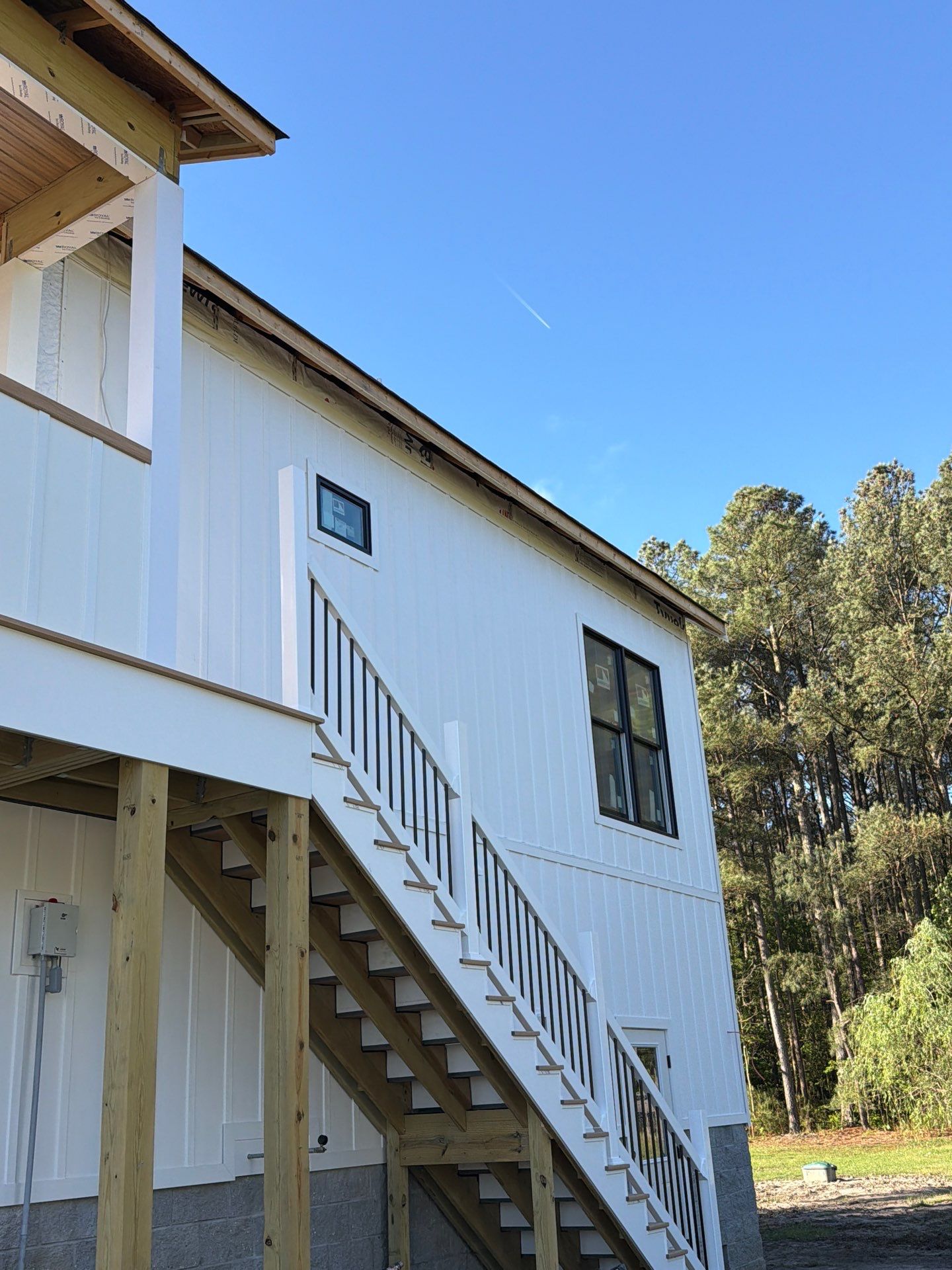 Two-Story Custom Home With Board and Batten Siding by Cade Construction
