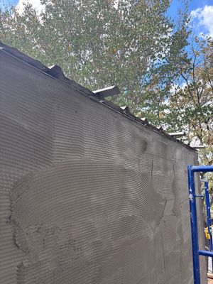 Close up of wall surface under construction with scaffolding