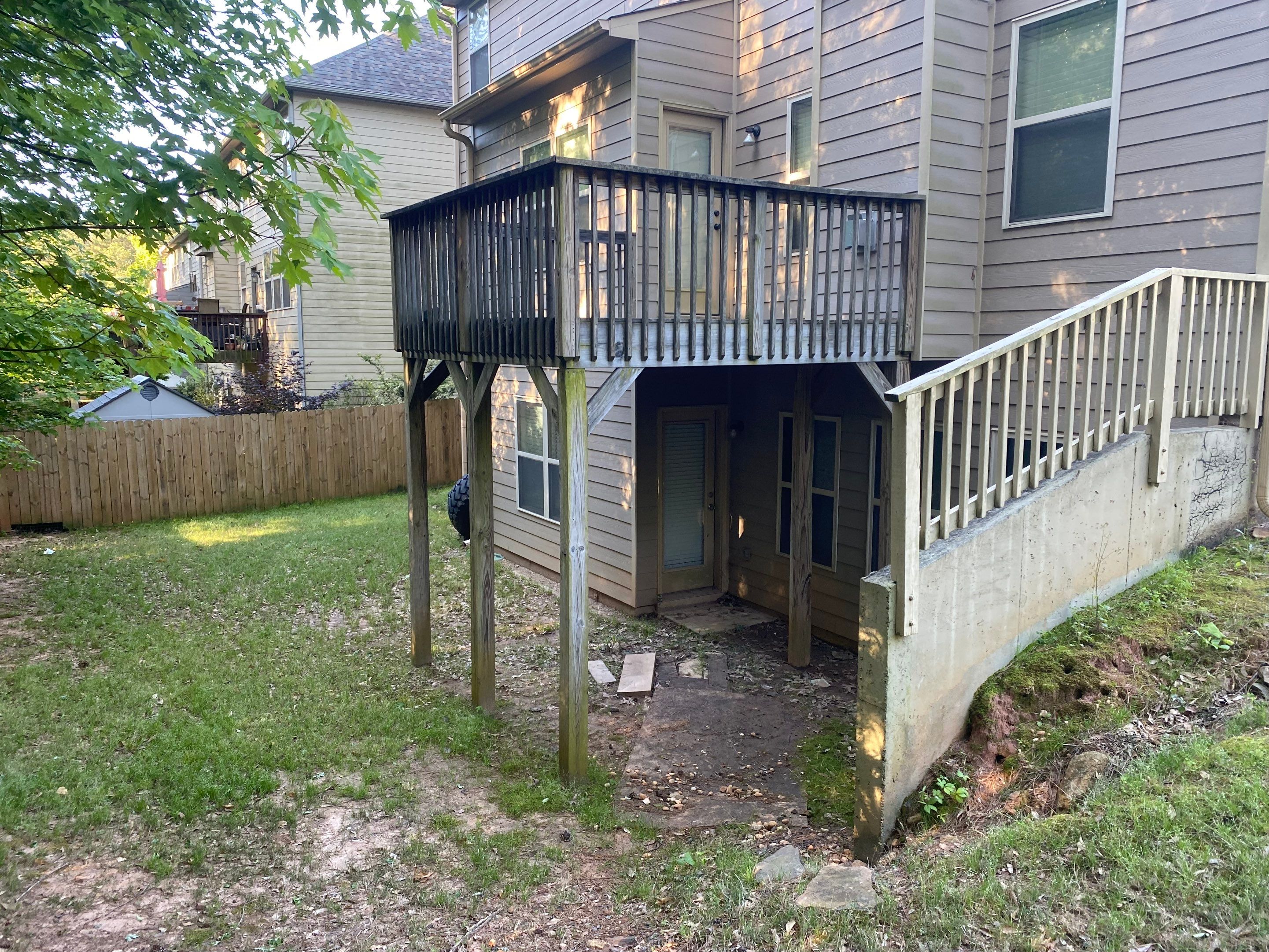 Custom Elevated Deck Replacement with White and Black Railings by Swift Home Renovations