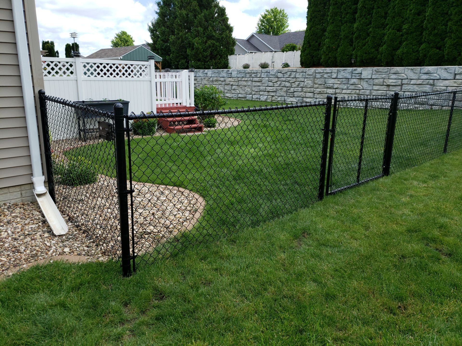 Black Vinyl-Coated Chain Link Fence Installation in Denver by Perfect Picket Fence and Stain
