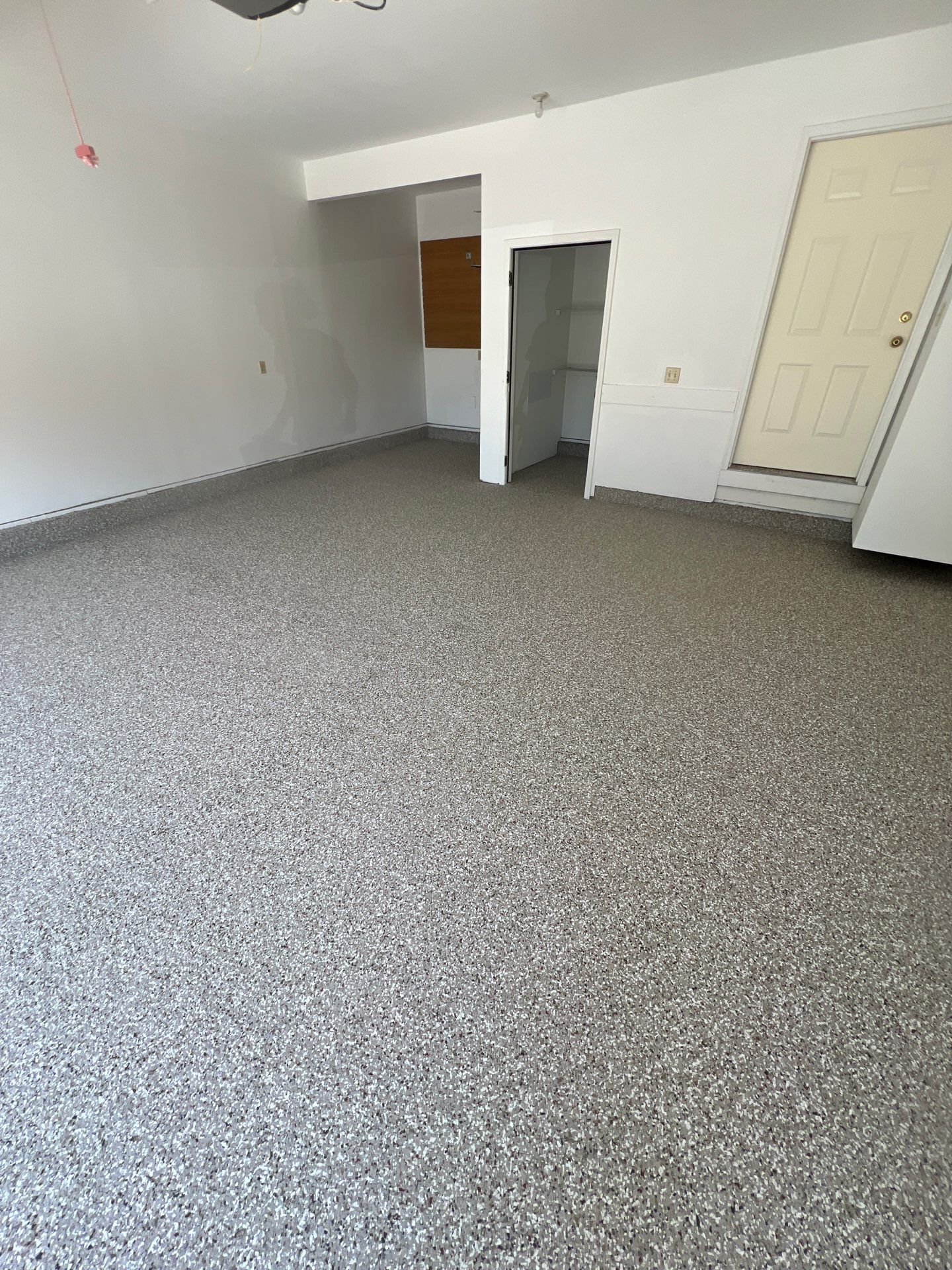Garage floor in Holt using Smoke Flake by Freedom Concrete Coatings. 