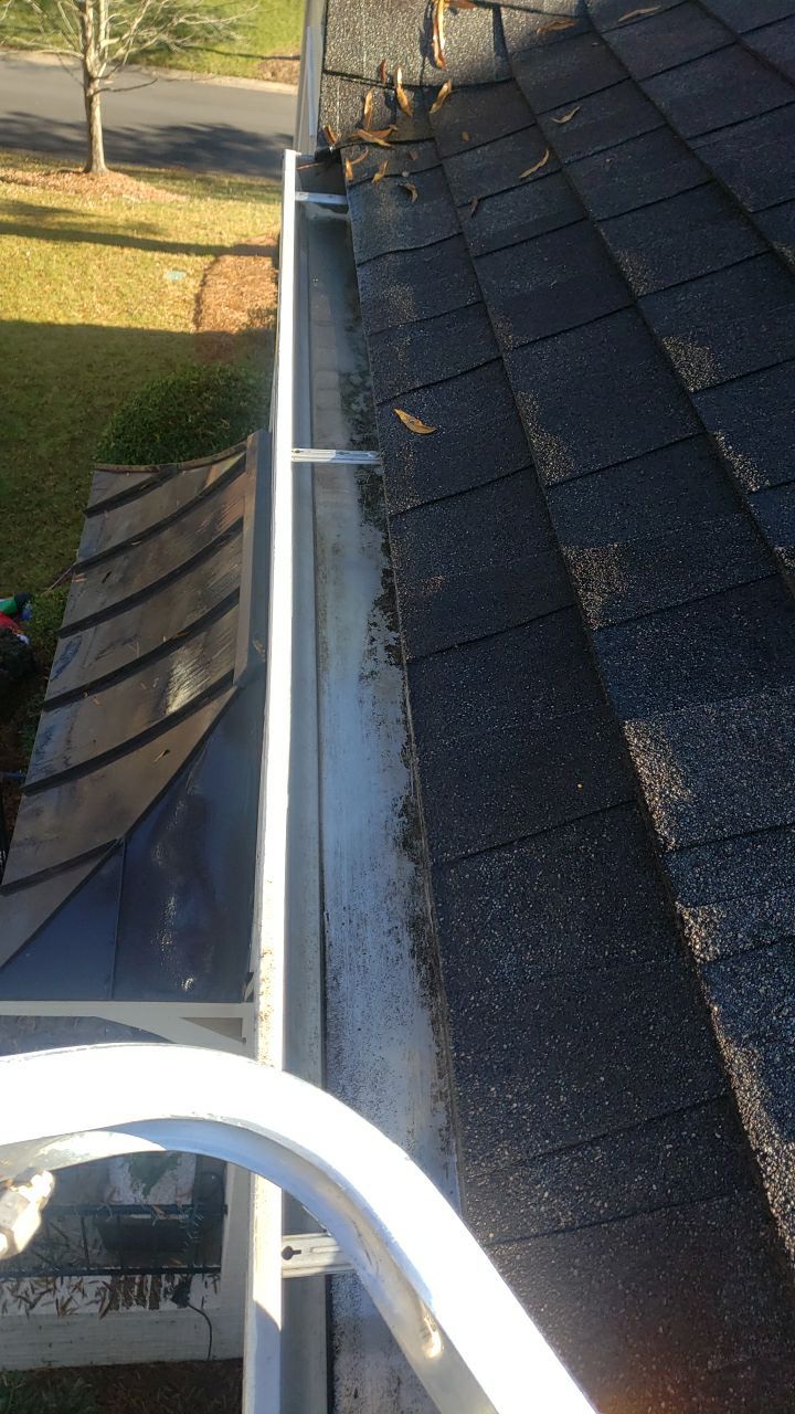 Sara Gutter cleanout using water by G&H Home Tech Pros LLC