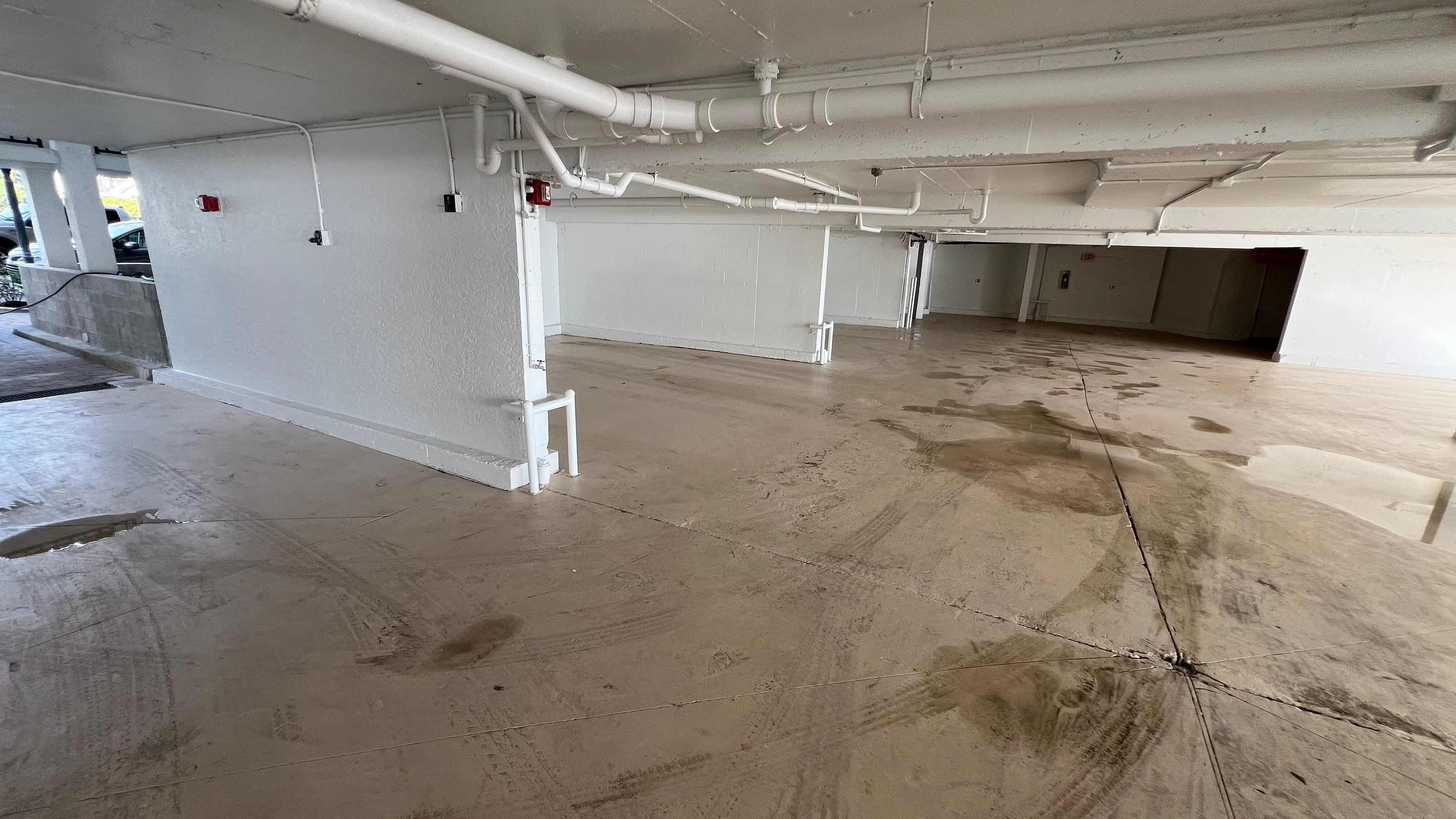 Isles of Capri Condo Parking Garage Drainage System Cleaning by APS Power & Water