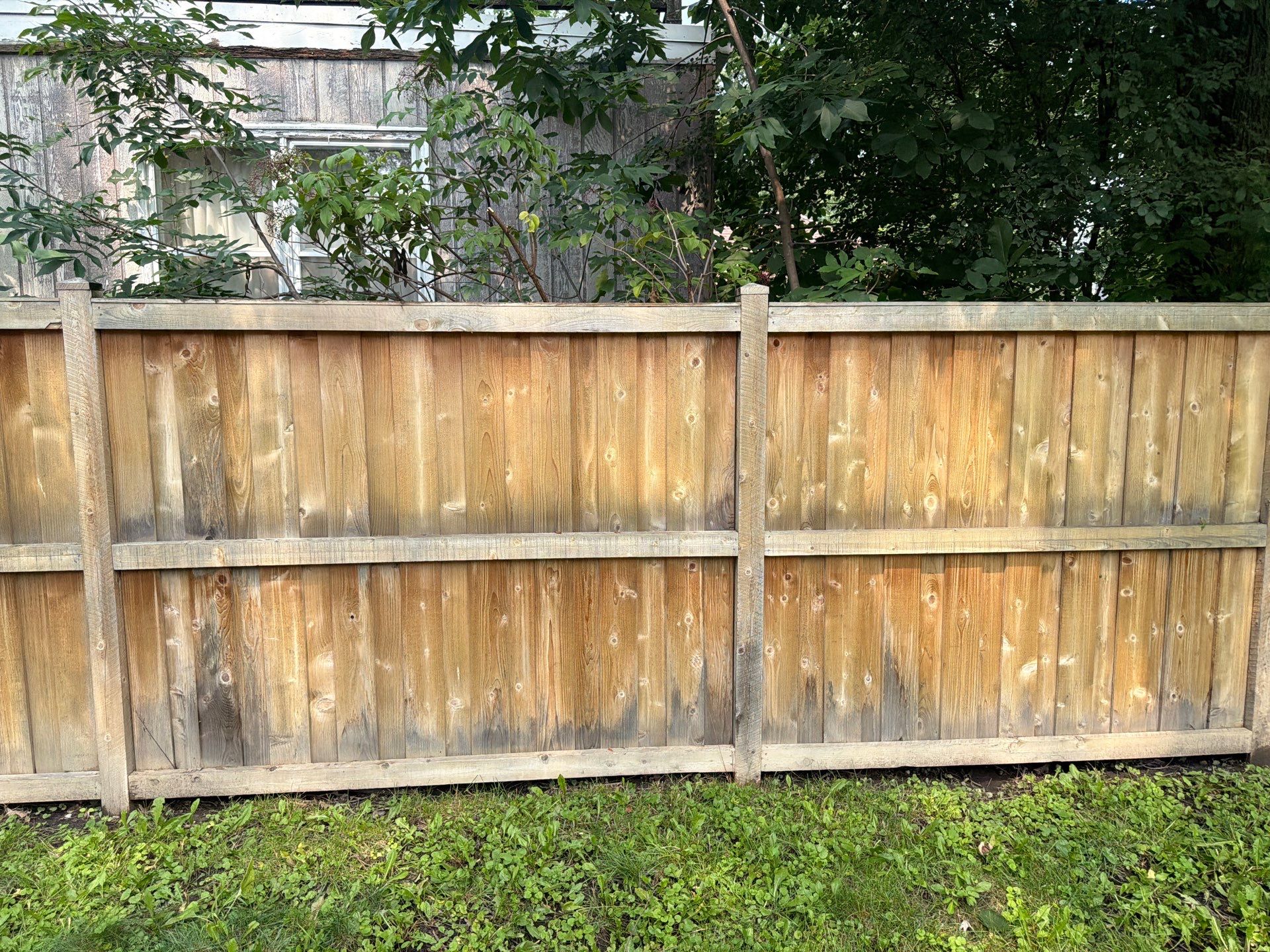 Wood fence cleaning and sealing by Northern Power Washing LLC.
