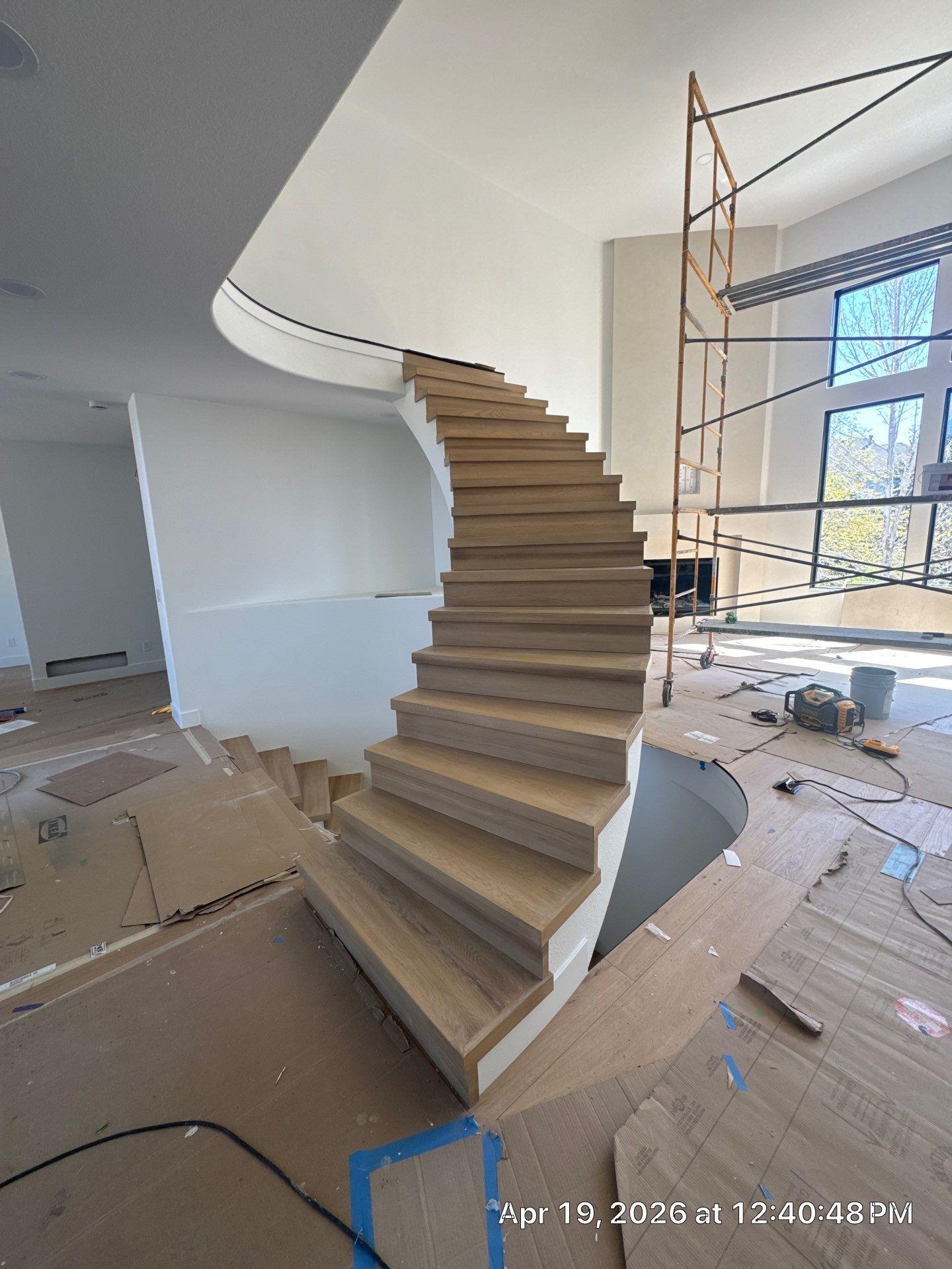 Curved Oak Staircase and Custom Metal Railing Installation in Lone Tree by LP Construction Services