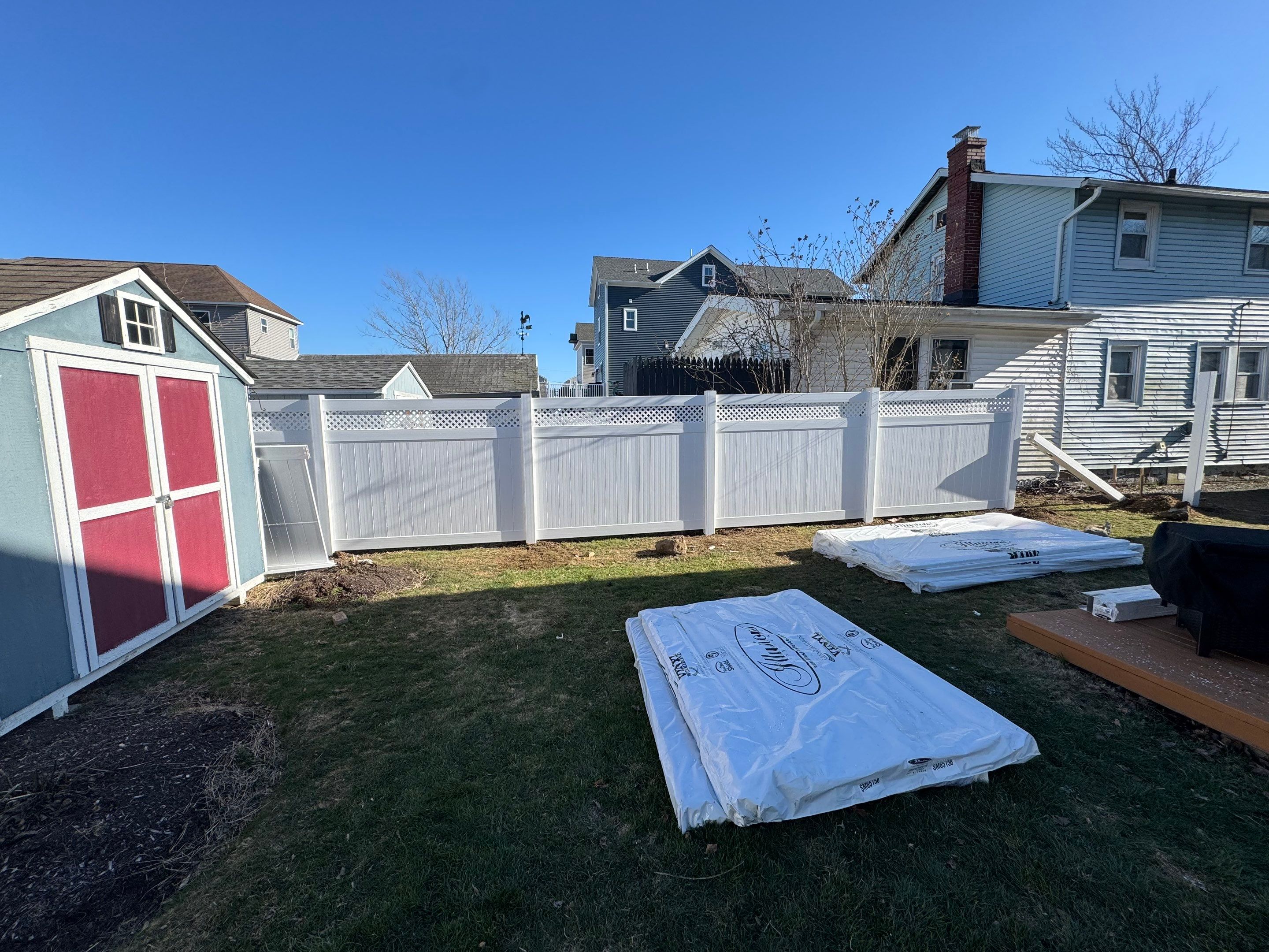 Fence install, White vinyl privacy fence with lattice accent. by DiGiorgi Roofing and Siding Inc