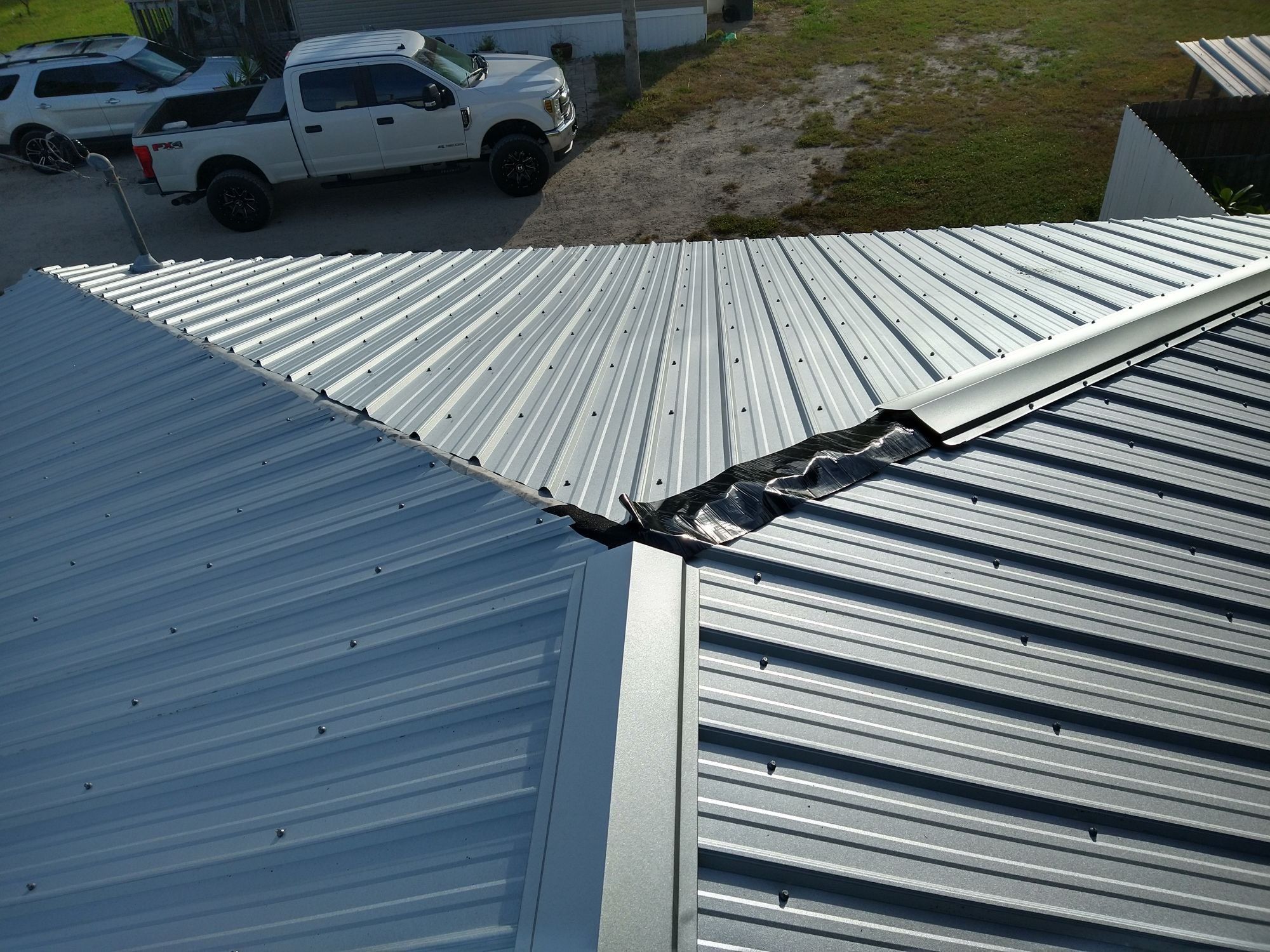 Residential Roofing Installation using 26 GA Rib Panel Galvalume by 1st Class Roofing, Inc.