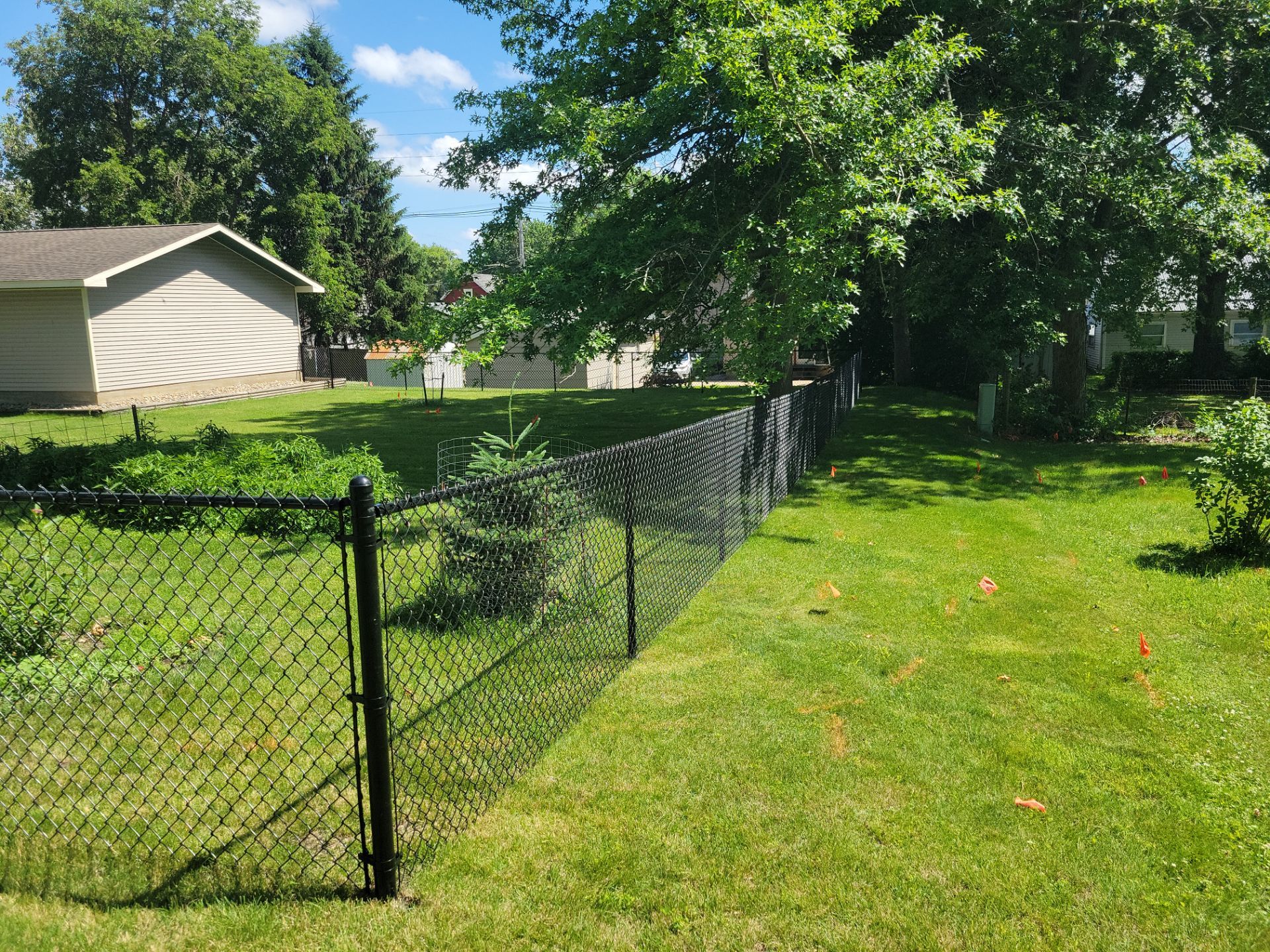 Black Chain Link Perimeter Fence and Driveway Gate in Waverly by Perfect Picket Fence and Stain