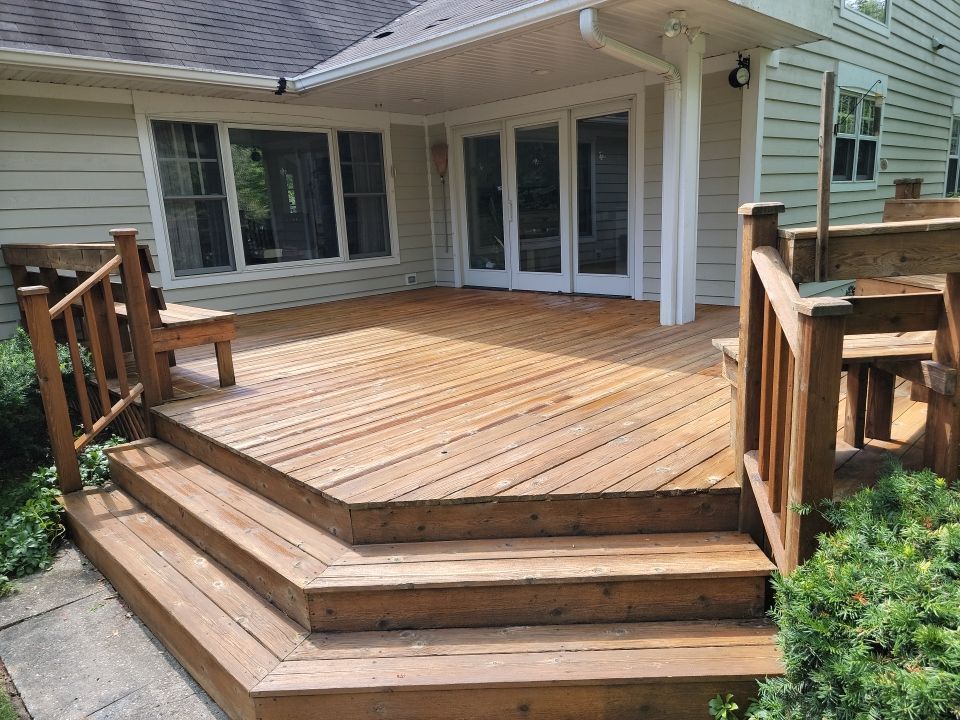Wood deck cleaning, board replacement and staining by Northern Power Washing LLC.