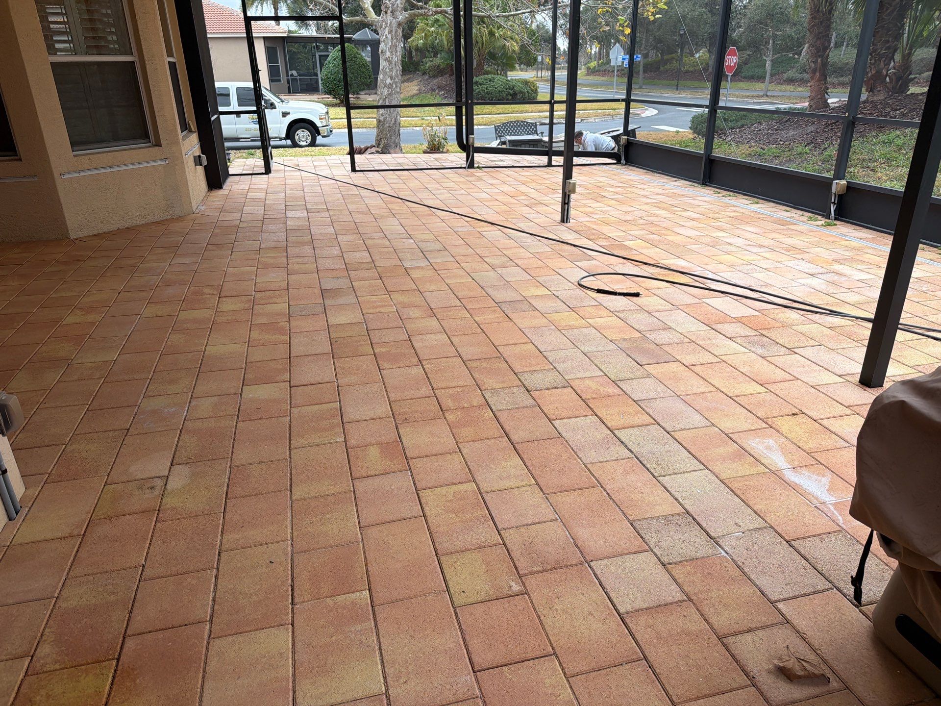Paver Sealing for Herringbone Driveway and Screened Lanai in Valencia Lakes by Supreme Paver Experts