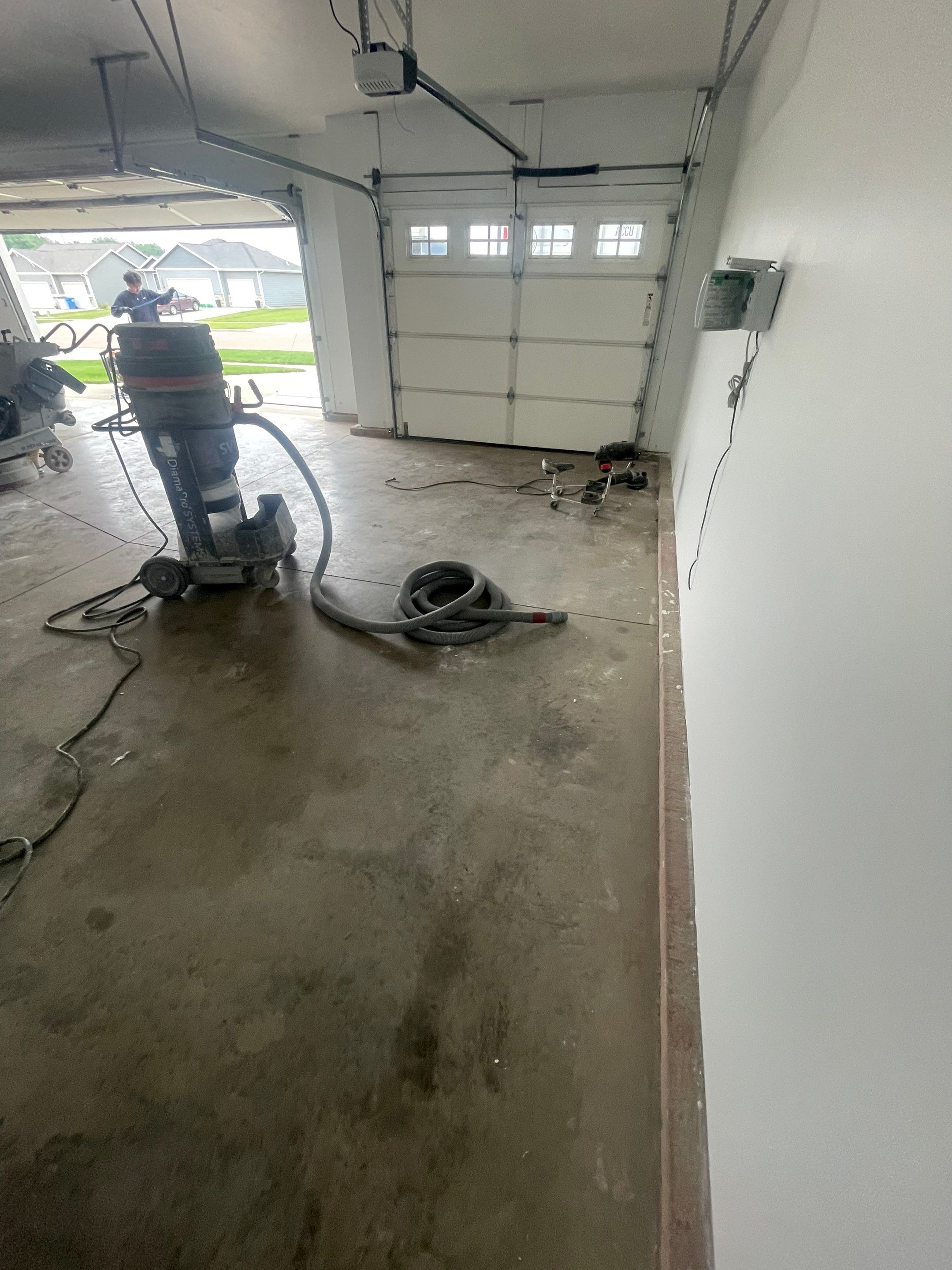 Grey Flake Epoxy Garage Floor Coating in Sioux Falls by Select Painting, Coatings & Garage Cabinets