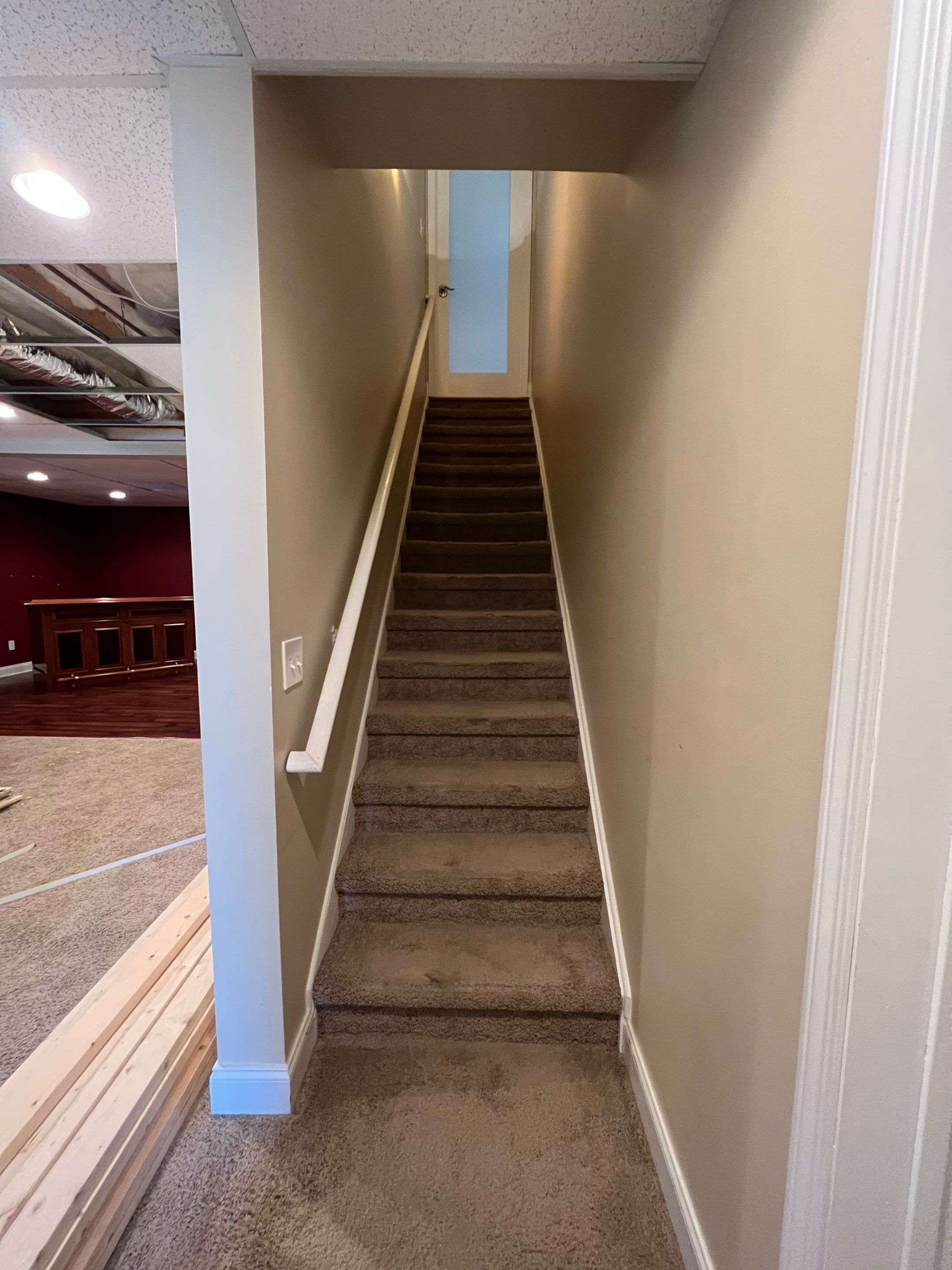 Modern Basement Remodeling in Woodstock with Custom Live-Edge Bar by Swift Home Renovations
