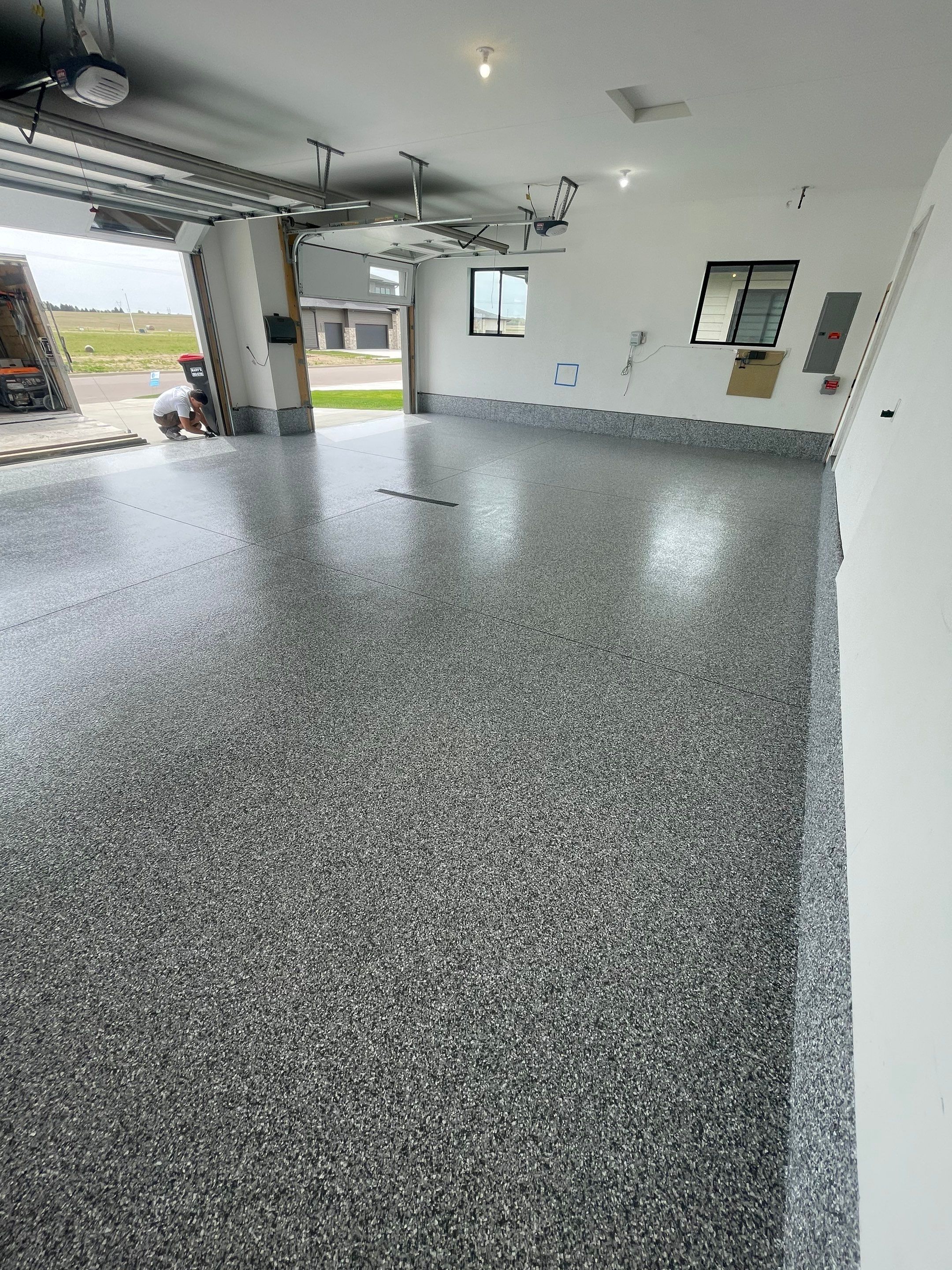 Full Garage Concrete Coating with Grey Speckled Epoxy in Brandon by Select Painting, Coatings & Garage Cabinets