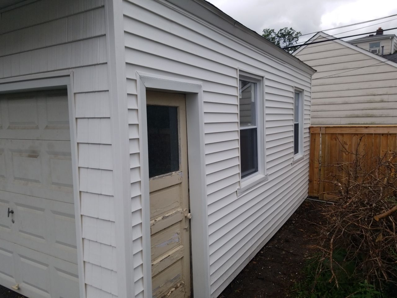 Residential Roofing Installation, Dec-tek walk-out porch roof, siding on garage by Absolute Roofing and Construction