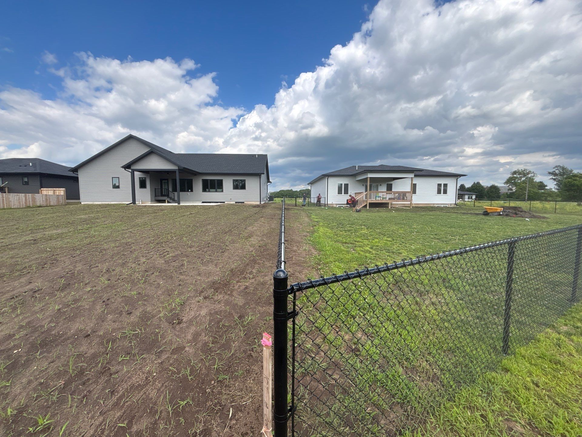 Black Vinyl-Coated Chain Link Fence and Residential Site Grading by Perfect Picket Fence and Stain