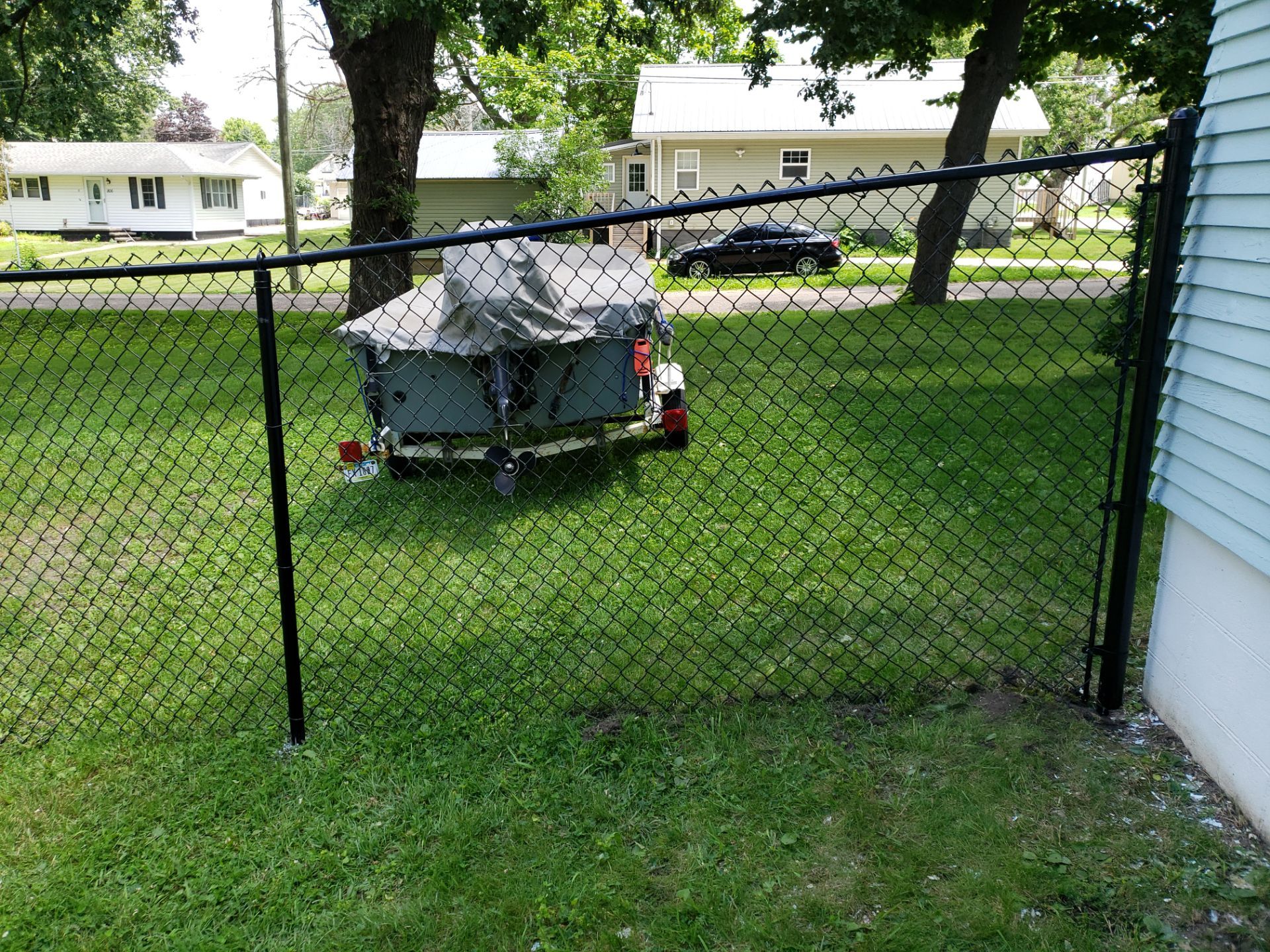 Black Vinyl Coated Chain Link Fence Installation in Independence by Perfect Picket Fence and Stain