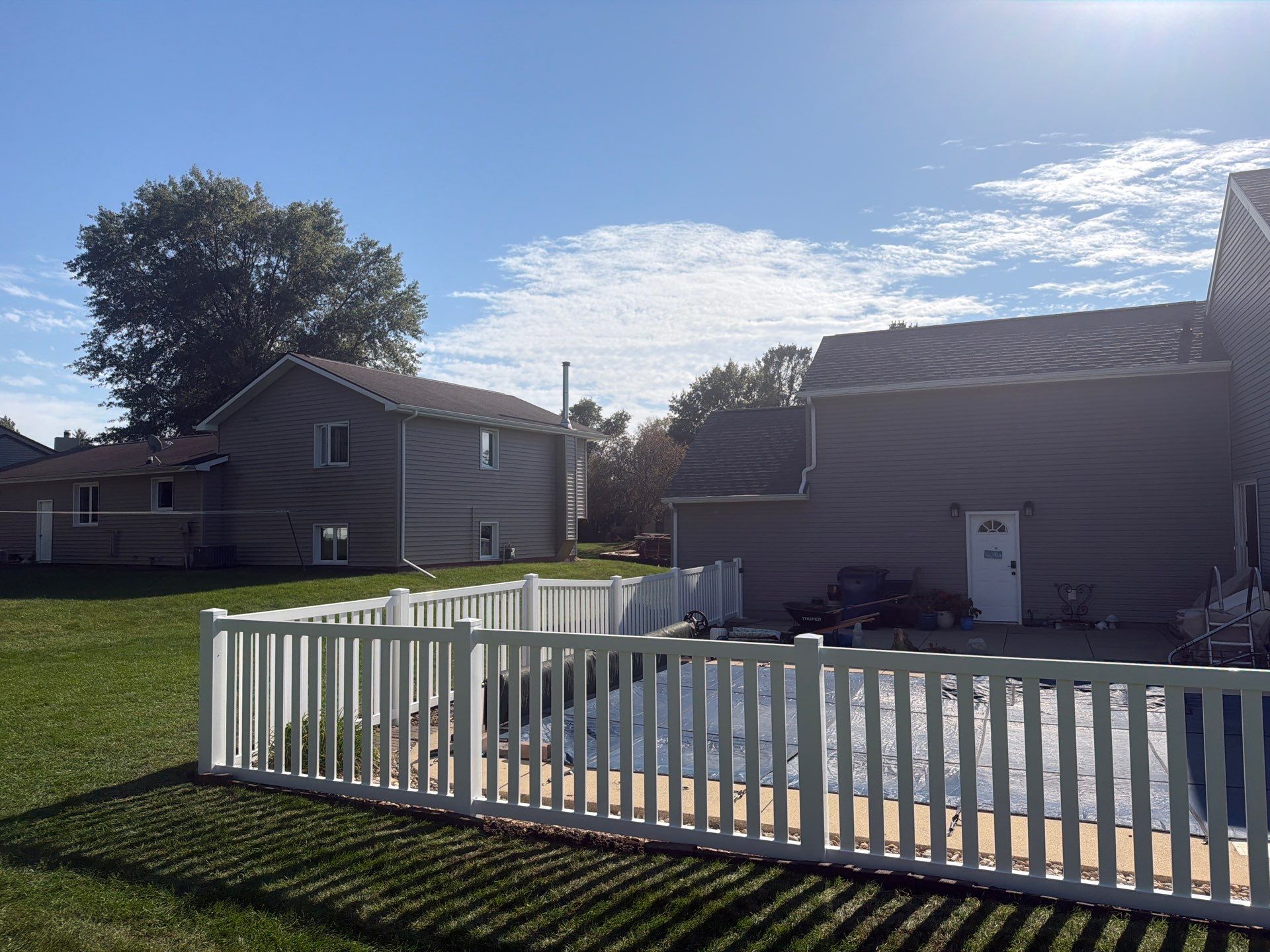 White Vinyl Picket Pool Fence Installation in Waterloo, Iowa by Perfect Picket Fence and Stain