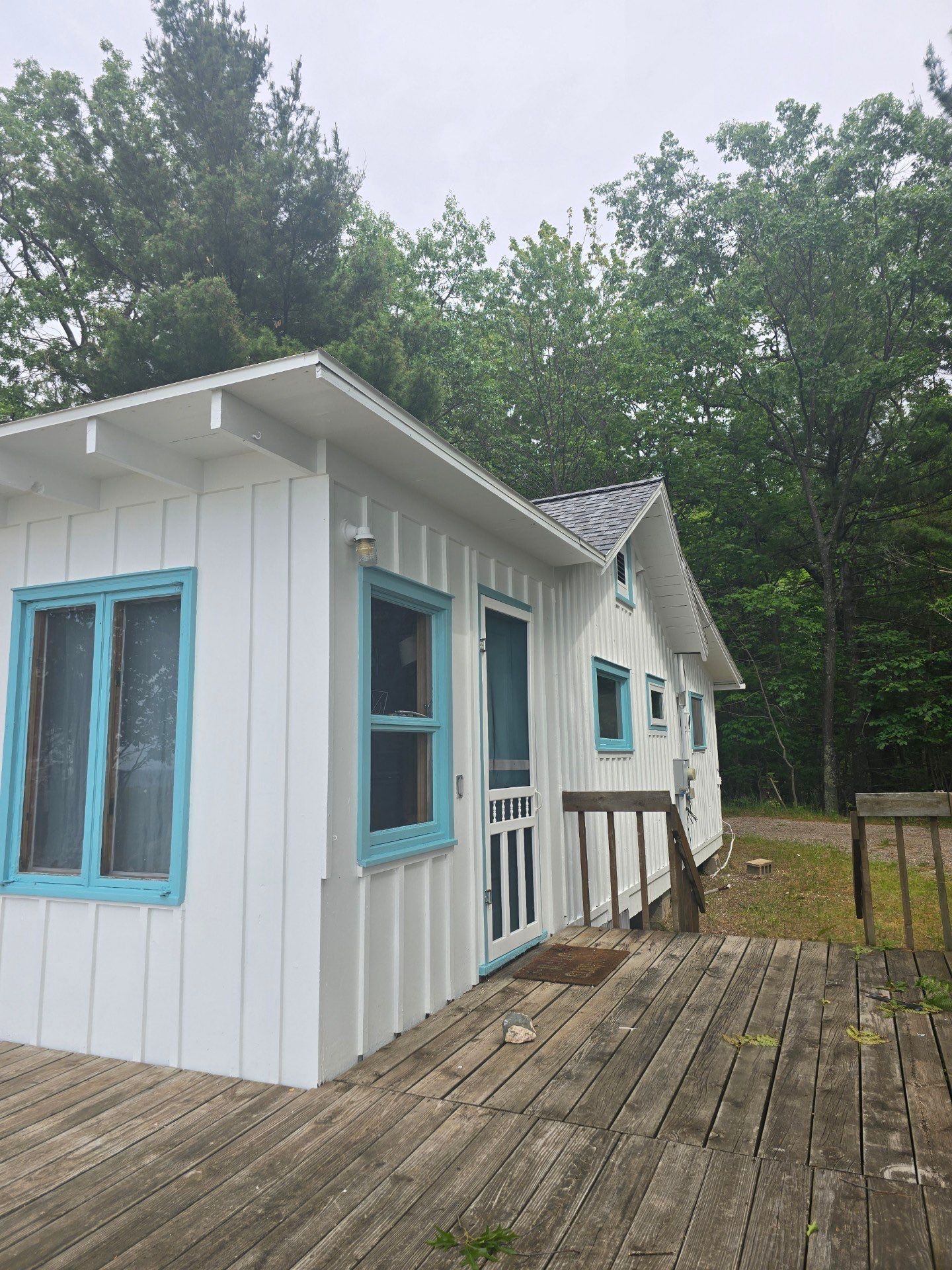 Lakeside Cottage Exterior Painting and Teal Trim Restoration in Mears by Gordon Painting