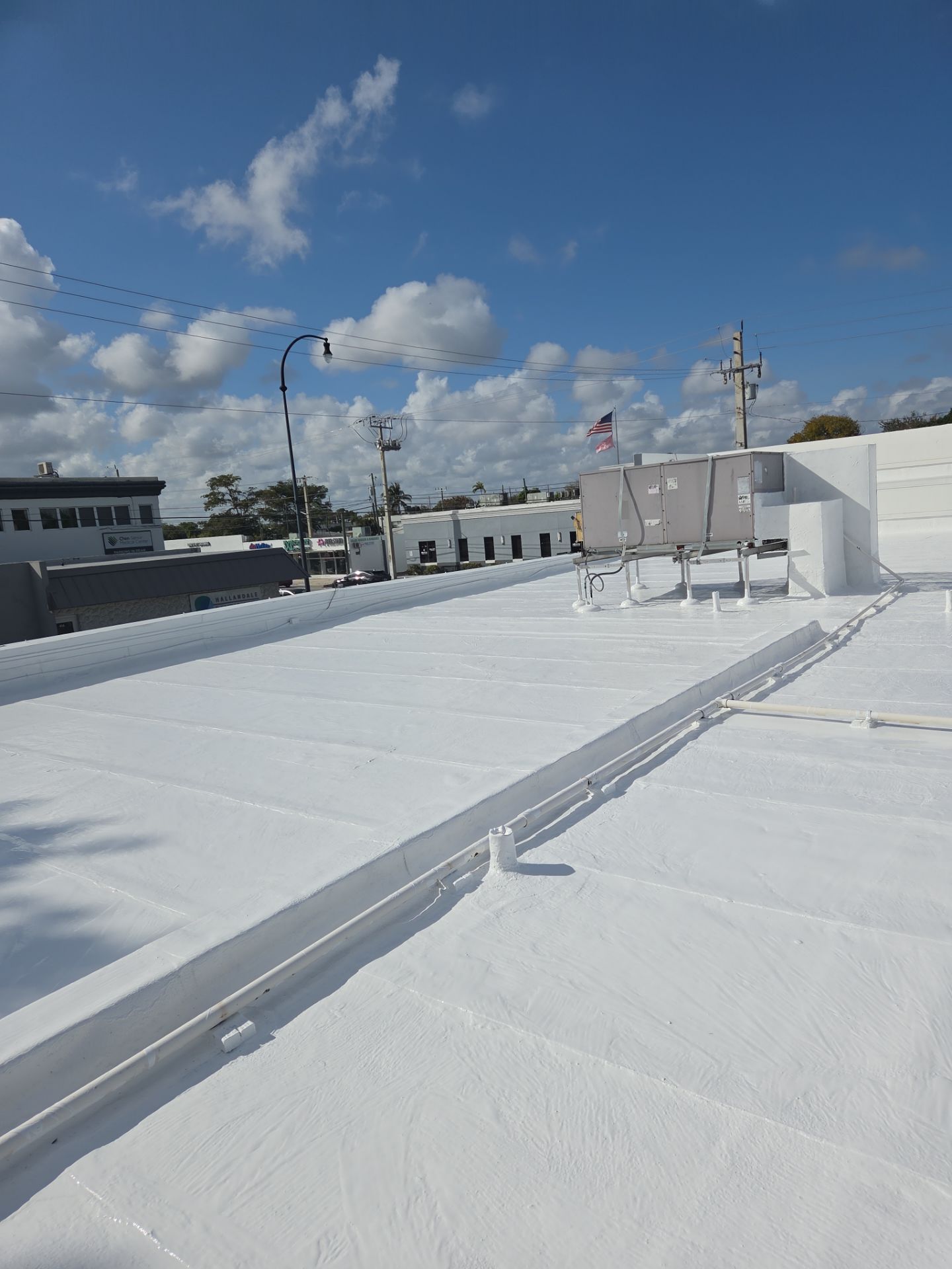 Commercial Flat Roof Restoration Using Silicone Coating in Hallandale Beach by Aastro Roofing