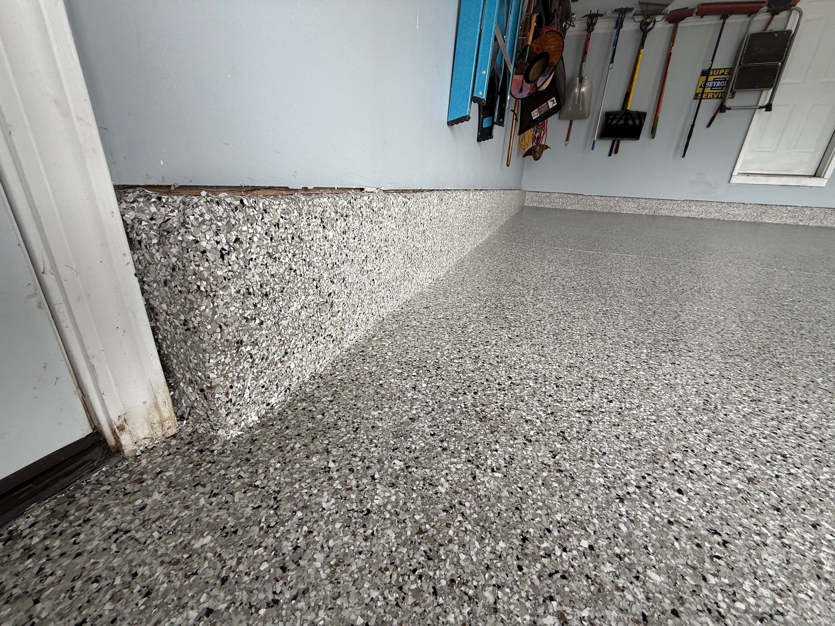 High-Gloss Epoxy Garage Floor Coating in Sioux Falls by Select Painting, Coatings & Garage Cabinets