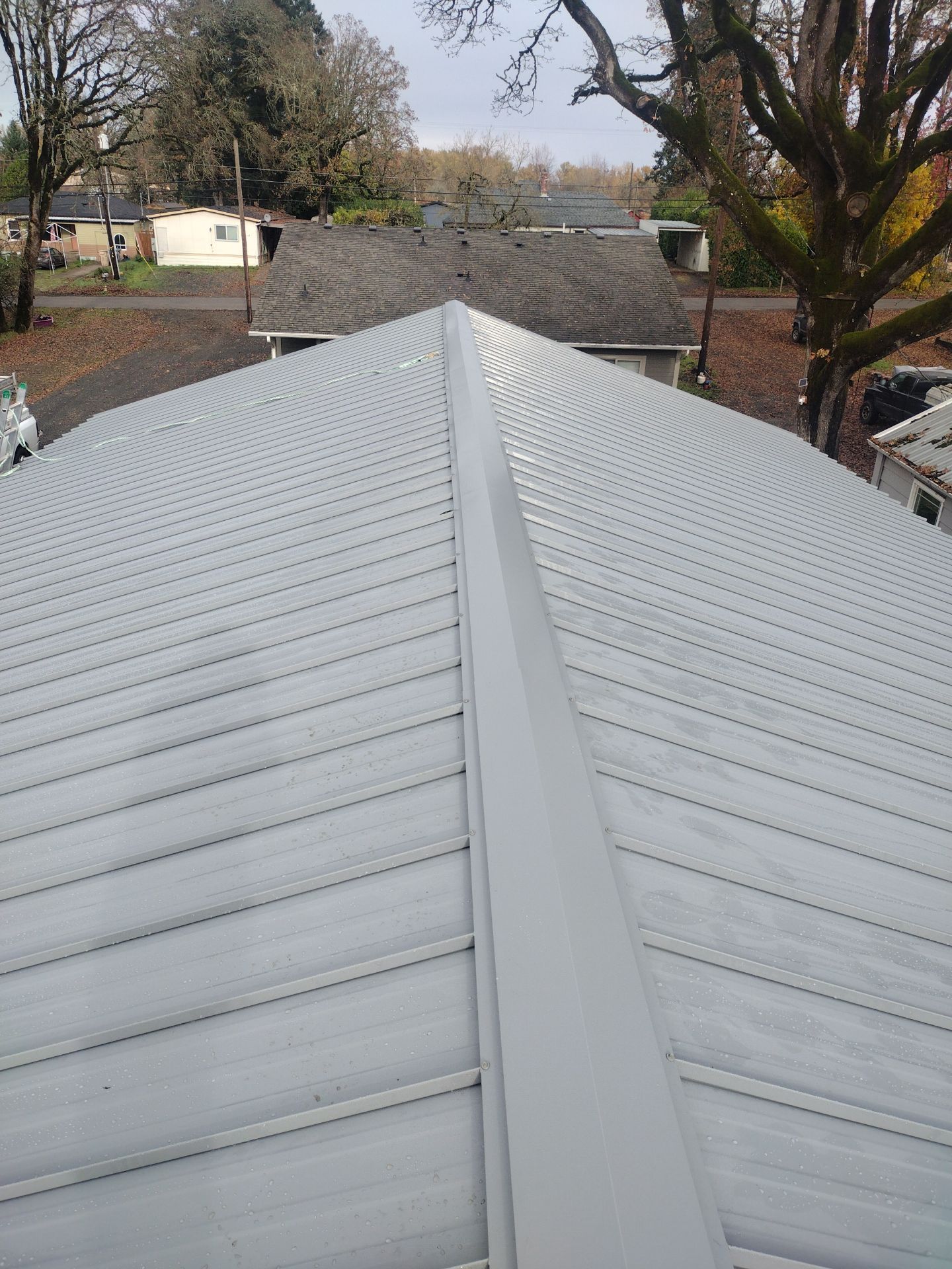 Grey Habitat for Humanity Metal Roof by Orezona Building & Roofing Company, Inc.