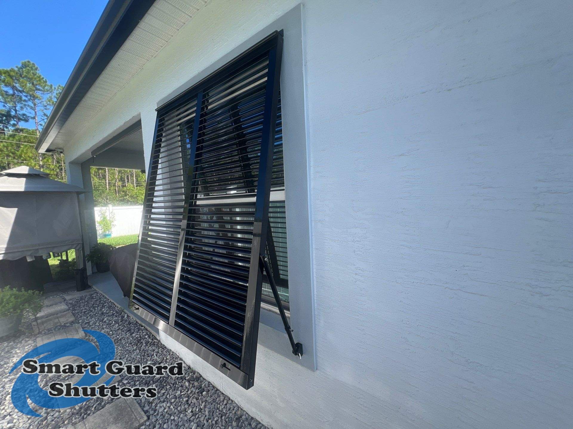 Impact Bahama Shutters in Jet Black by Smart Guard Shutters