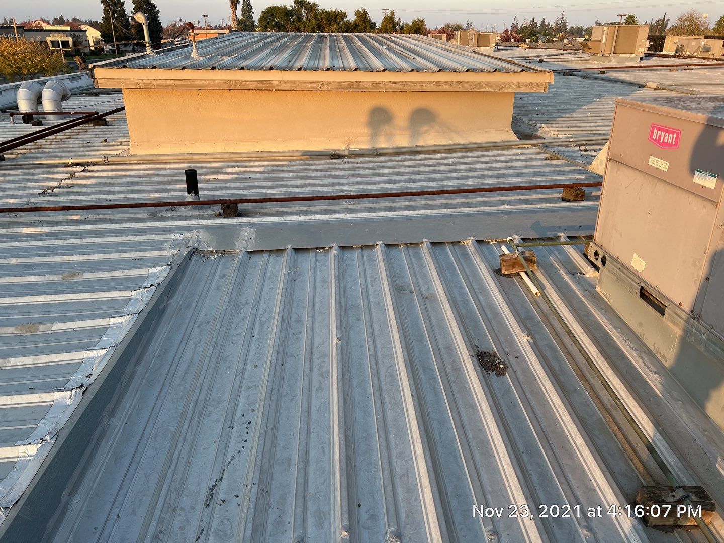 Metal roof restoration on commercial roof using Conklin Benchmark/ PUMA XL acrylic coatings over metal and foam by Straight Edge Roofing Inc