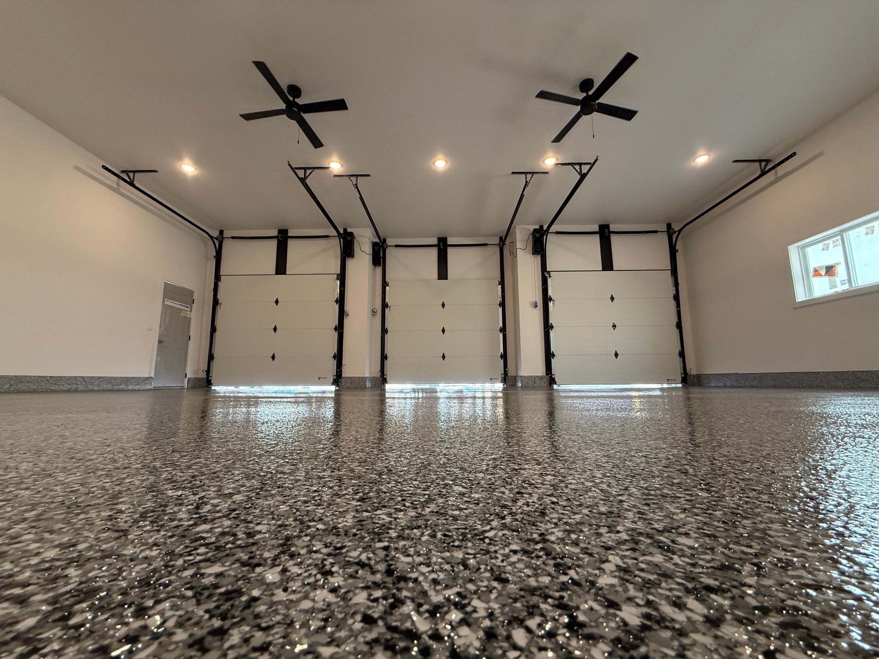 Multi-Car Garage Epoxy Floor Coating and Concrete Finishing in Sioux Falls by Select Painting, Coatings & Garage Cabinets