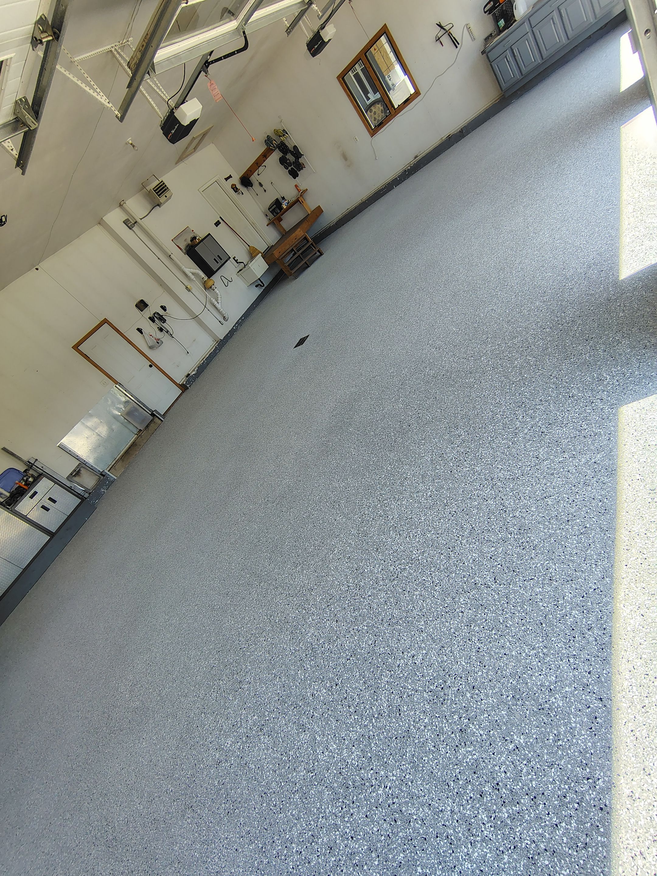 Feather Grey Garage Floor Coating Installation in Valley Springs by Select Painting, Coatings & Garage Cabinets