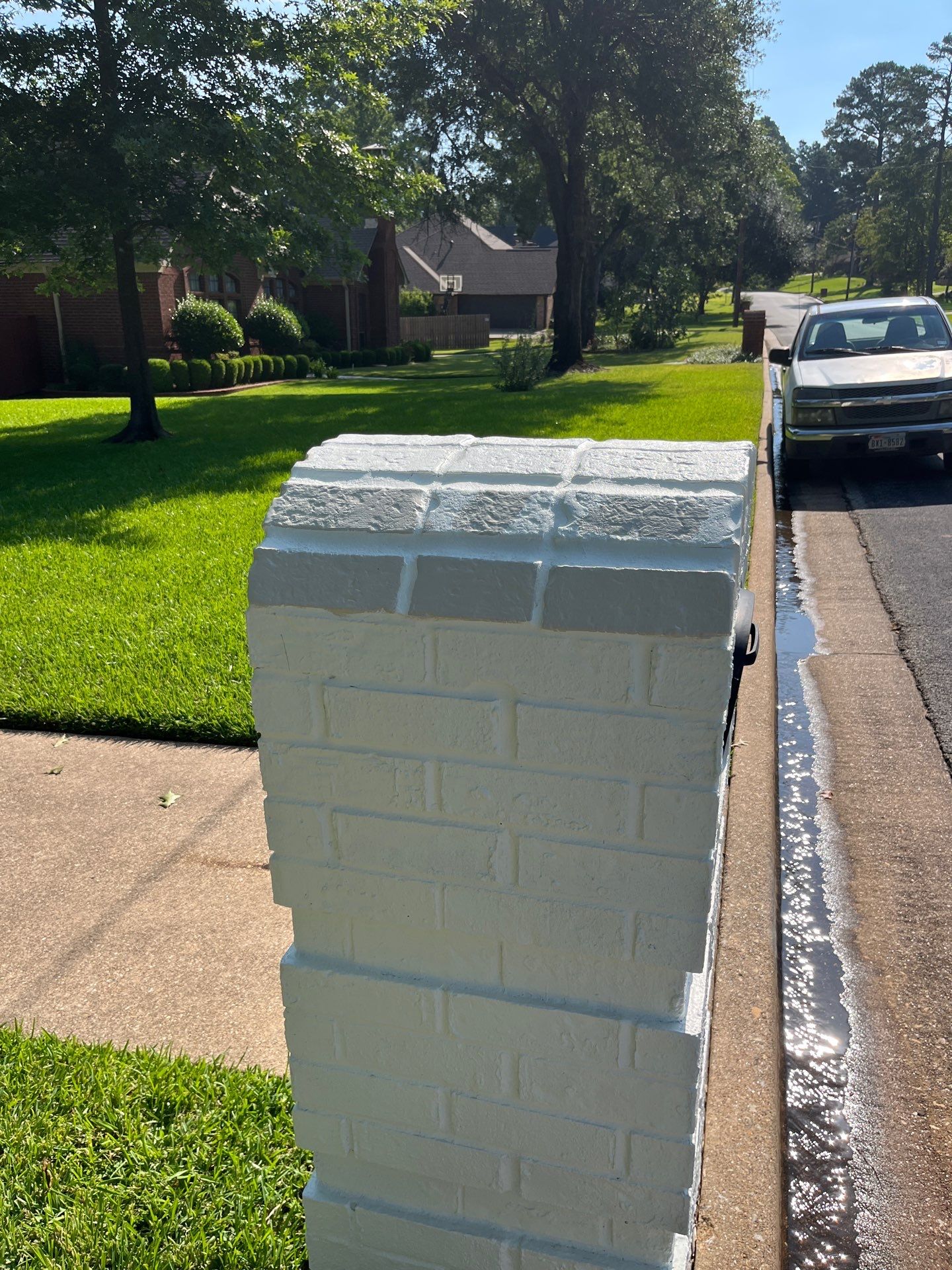 Exterior Painting in Tyler, TX | Brick House with White & Blue Finish by Quality Coats Painting
