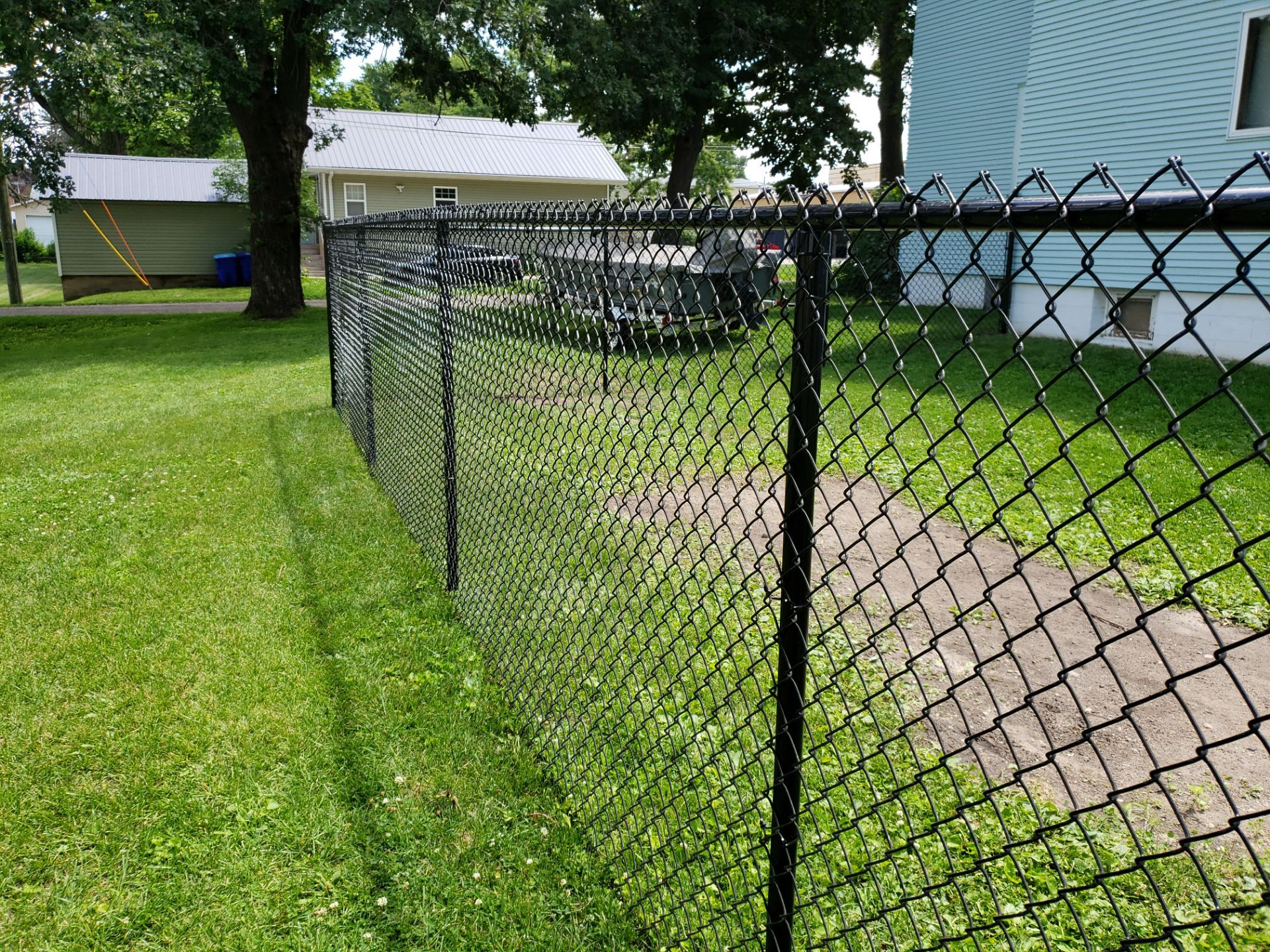 Black Vinyl Coated Chain Link Fence Installation in Independence by Perfect Picket Fence and Stain