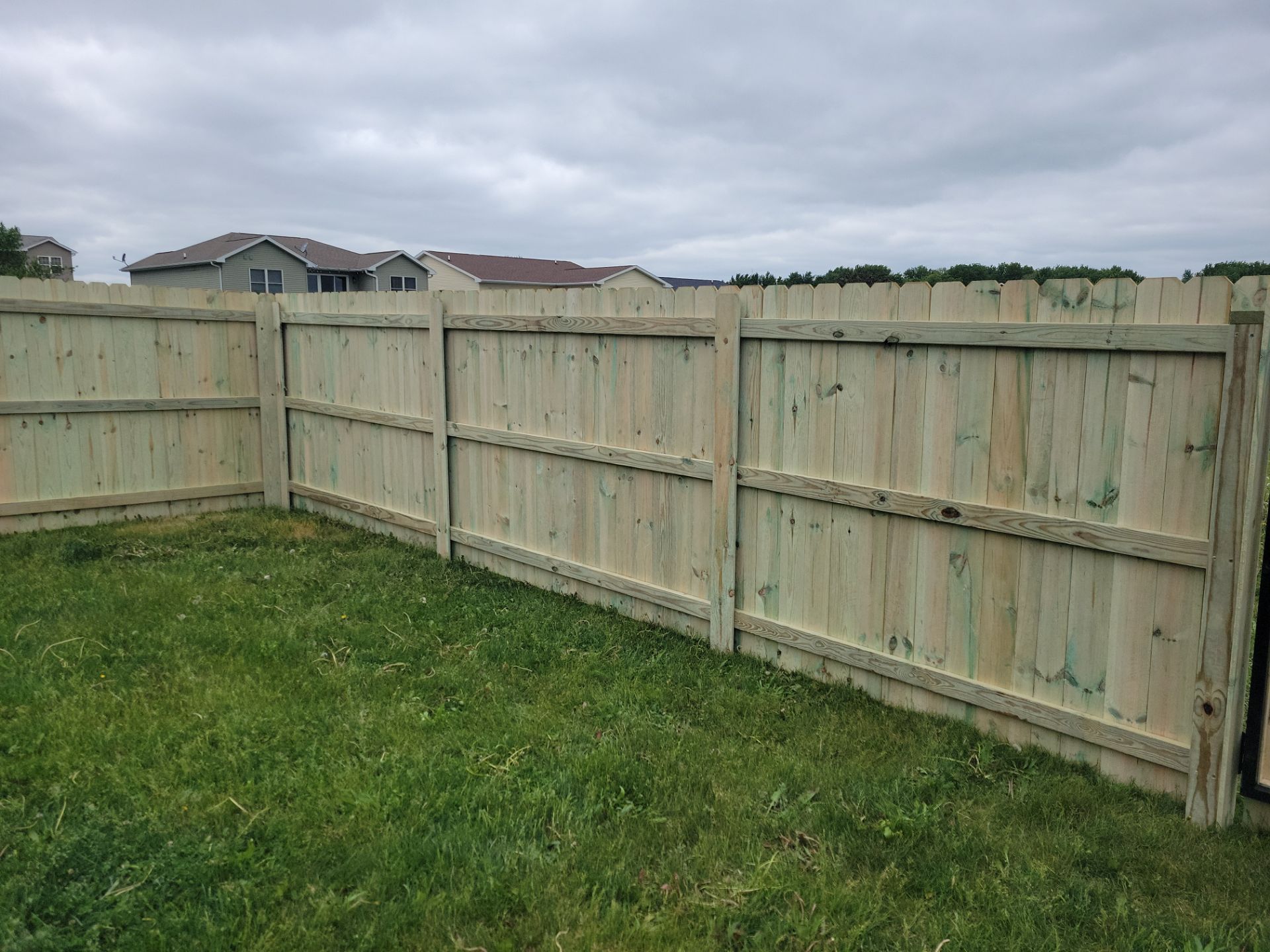 Pressure-Treated Wood Privacy Fence Installation in Waterloo by Perfect Picket Fence and Stain