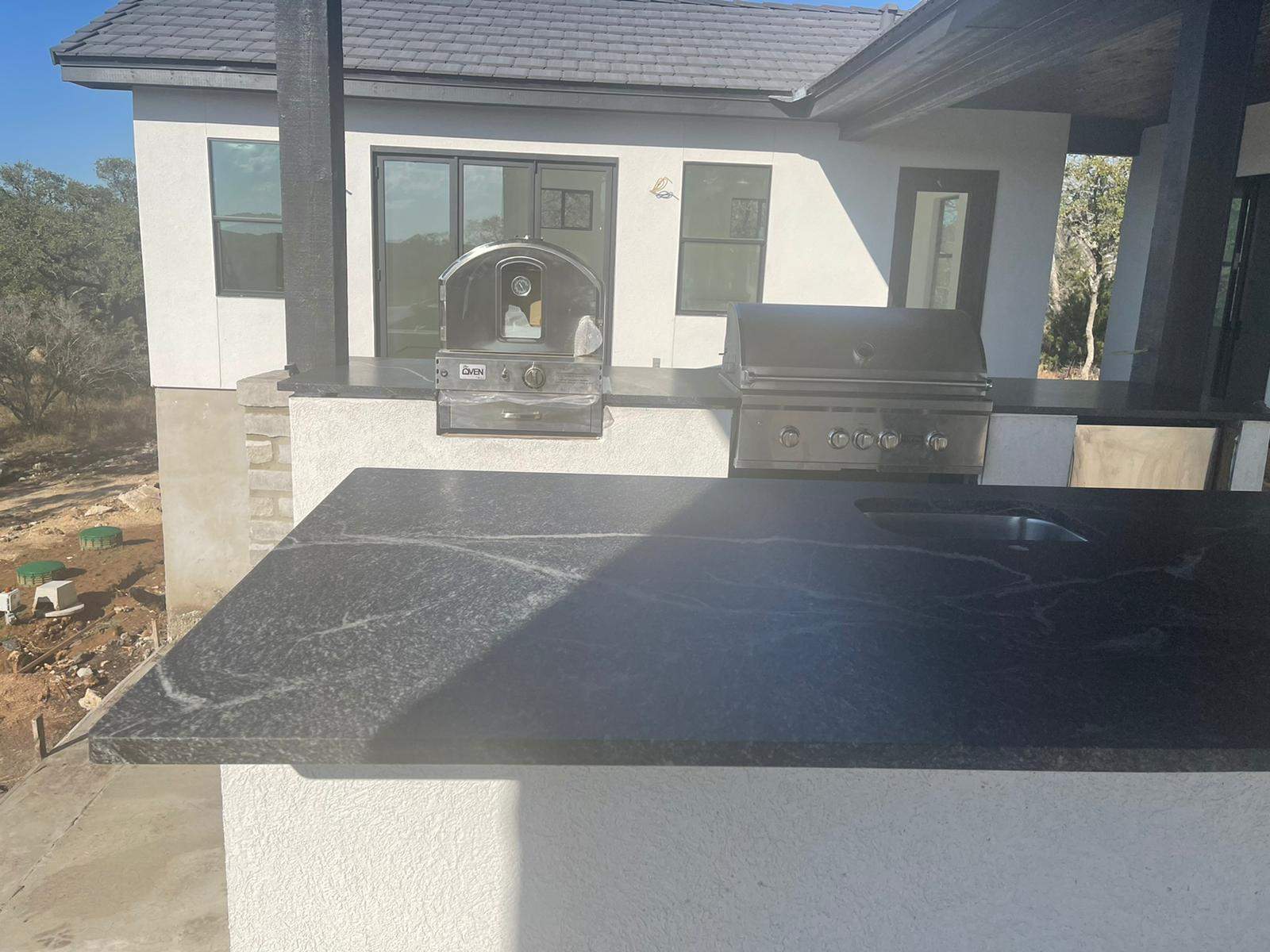 Outdoor kitchen using Black mist honed granite by Mena stone surfaces