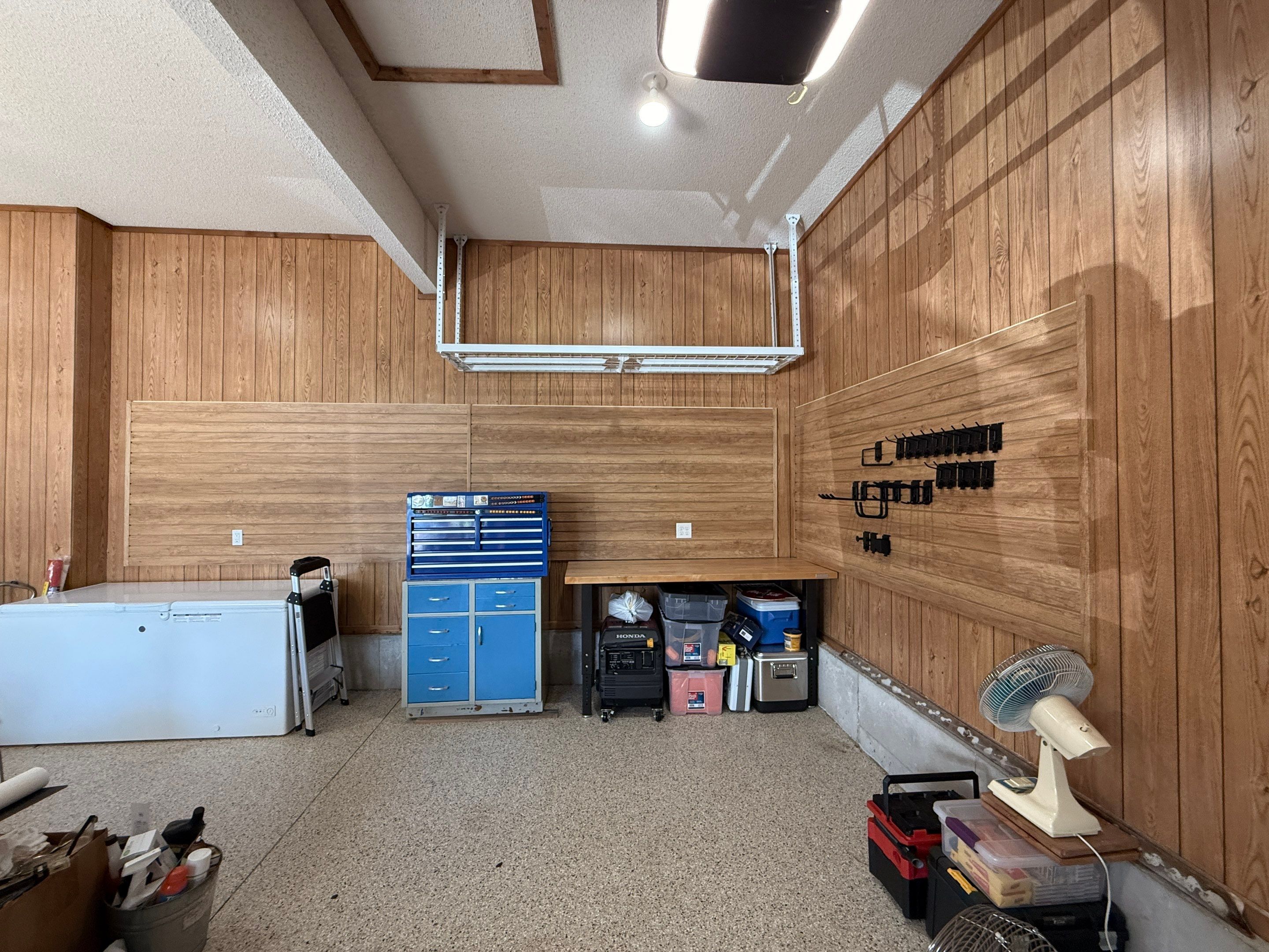 Garage Organization With Overhead Racks and Slatwall in Overland Park by Banner Garage