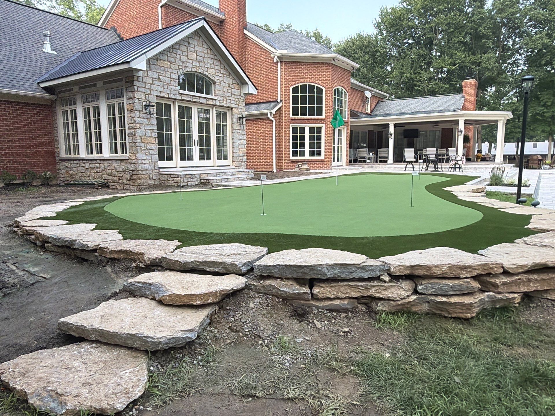 Custom Backyard Golf Green Accented by Flagstone Border in Morrow, OH by Southwest Greens Midwest