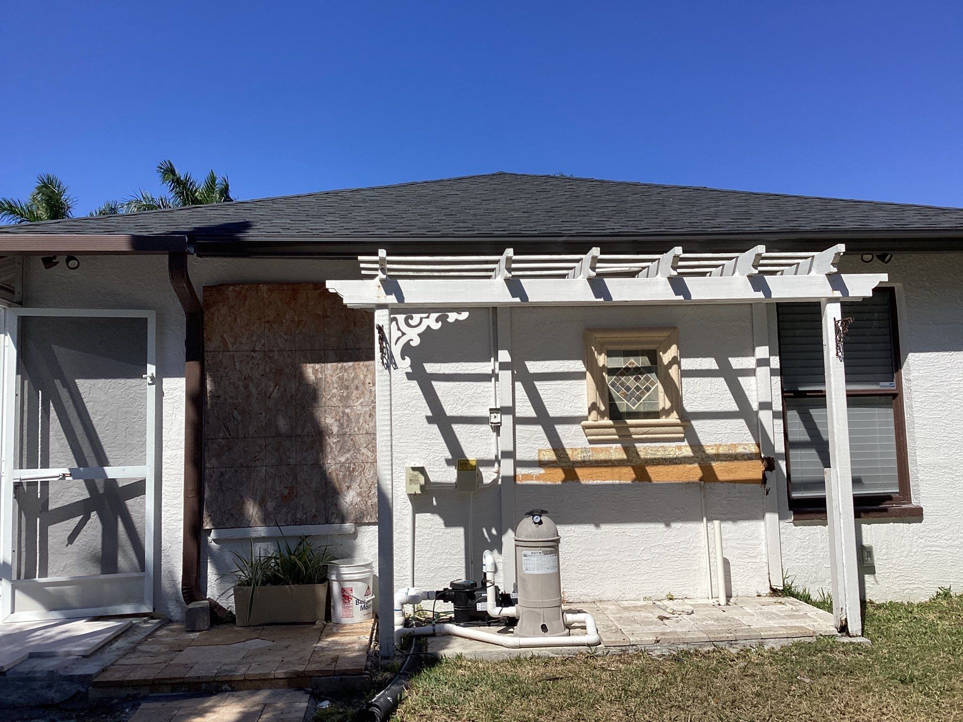 Brown Gutter + White and Brown Downspouts in Cape Coral FL by Gutter Professors
