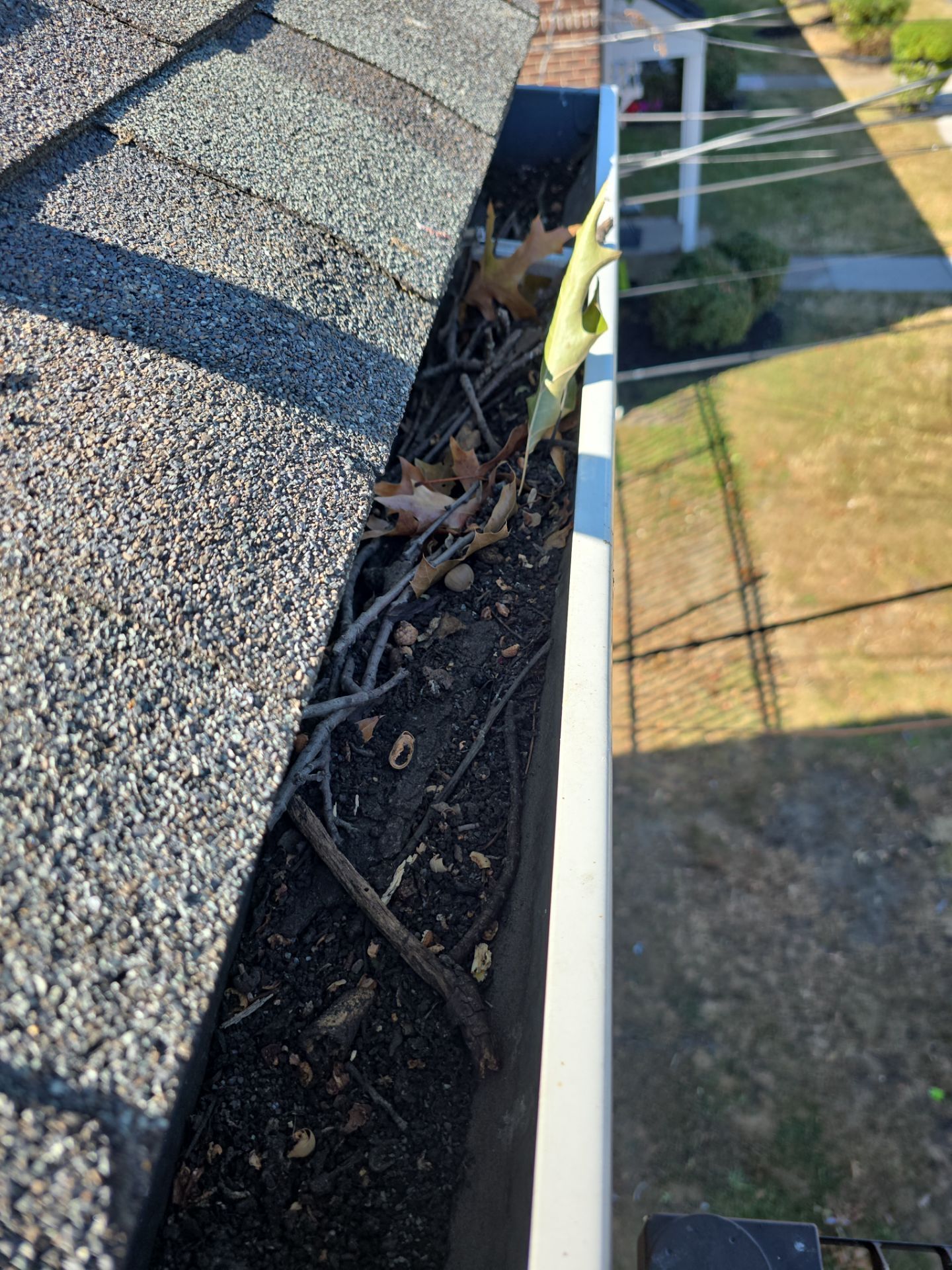 Commercial gutter cleaning Cherry Hill & Camden, NJ before photo with filled gutters