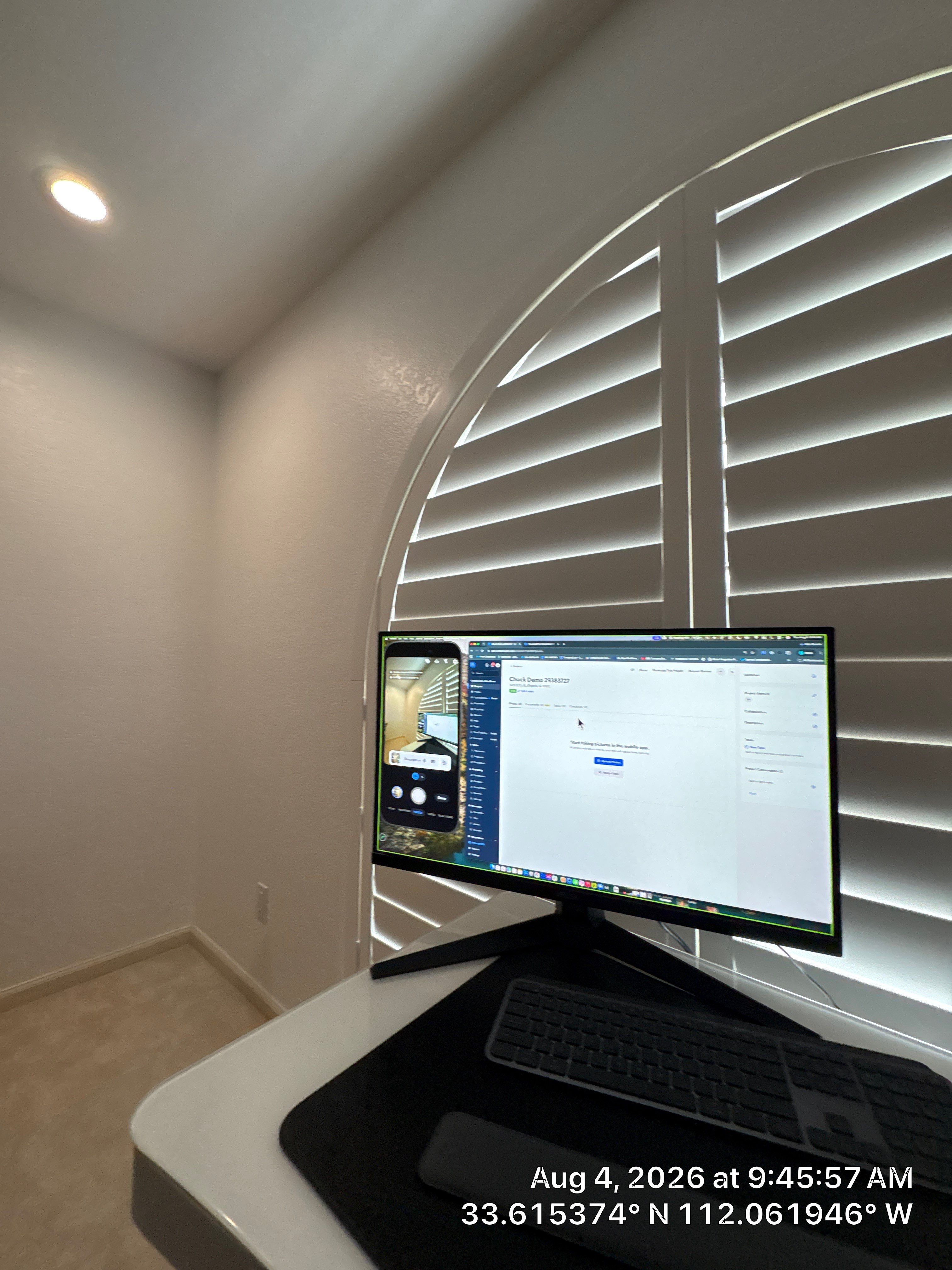 Custom Home Office Setup Featuring Arched Plantation Shutters and Accent Wall by CompanyCam Sales Demo