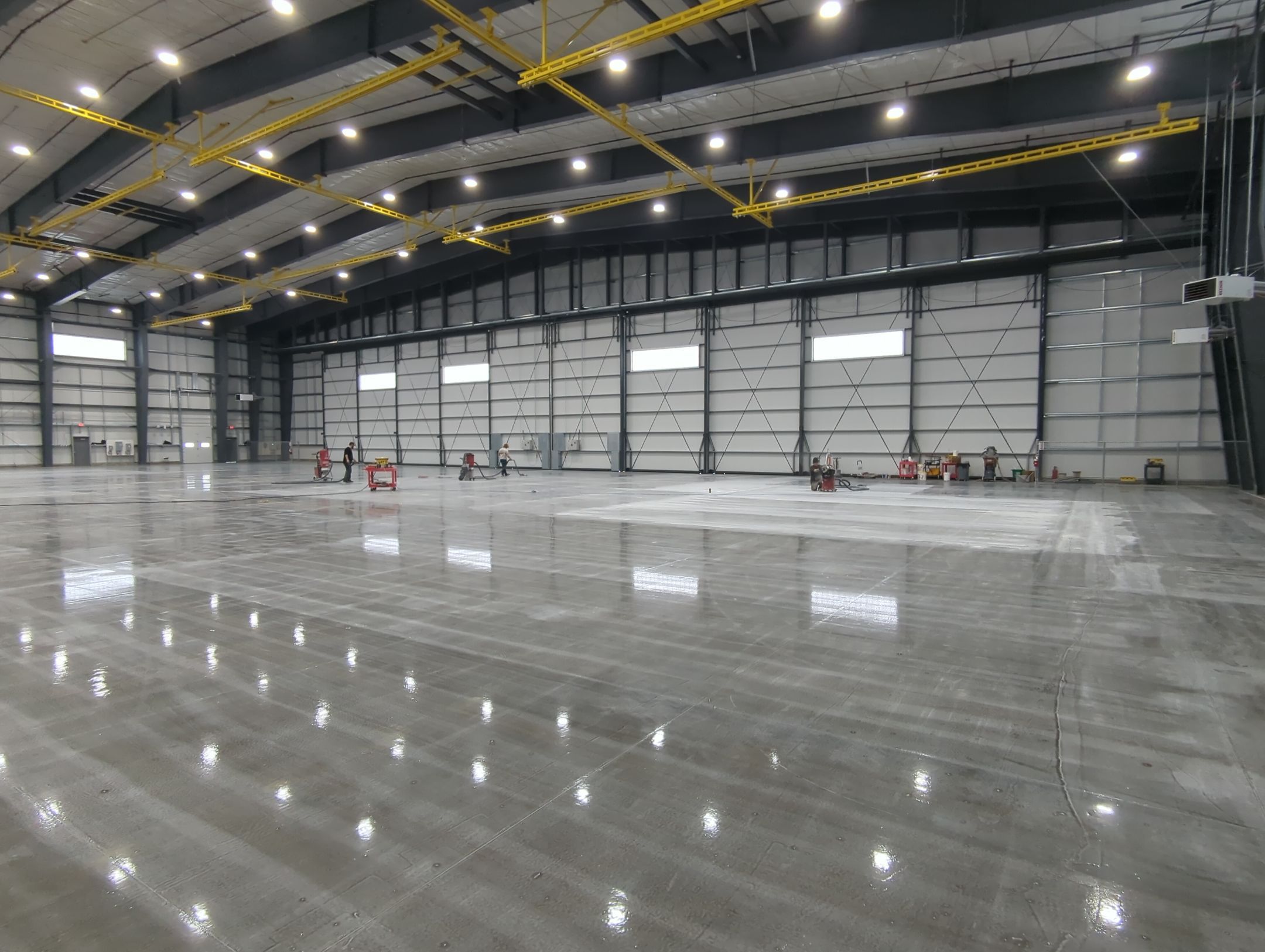 Airplane Hanger using Light Grey Commercial Penntek Epoxy by Croc Coatings, LLC