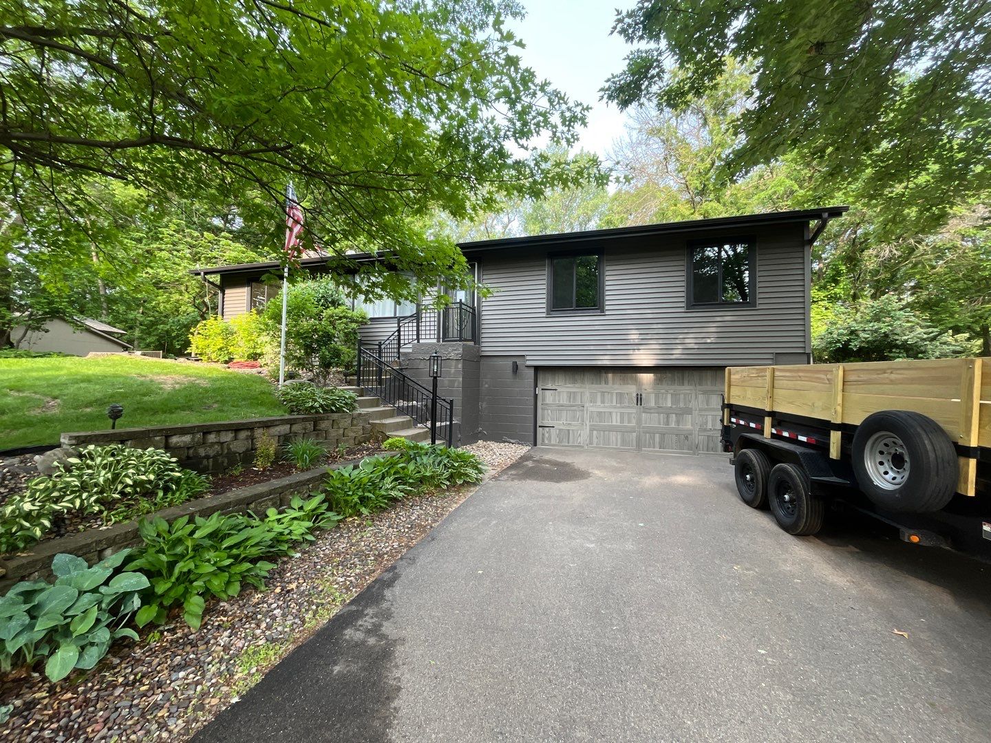 Premium Exterior Remodel – Alside Charter Oak Siding, Hayfield Black Frame Windows, Edco Soffit & Fascia by First Impressions Exteriors
