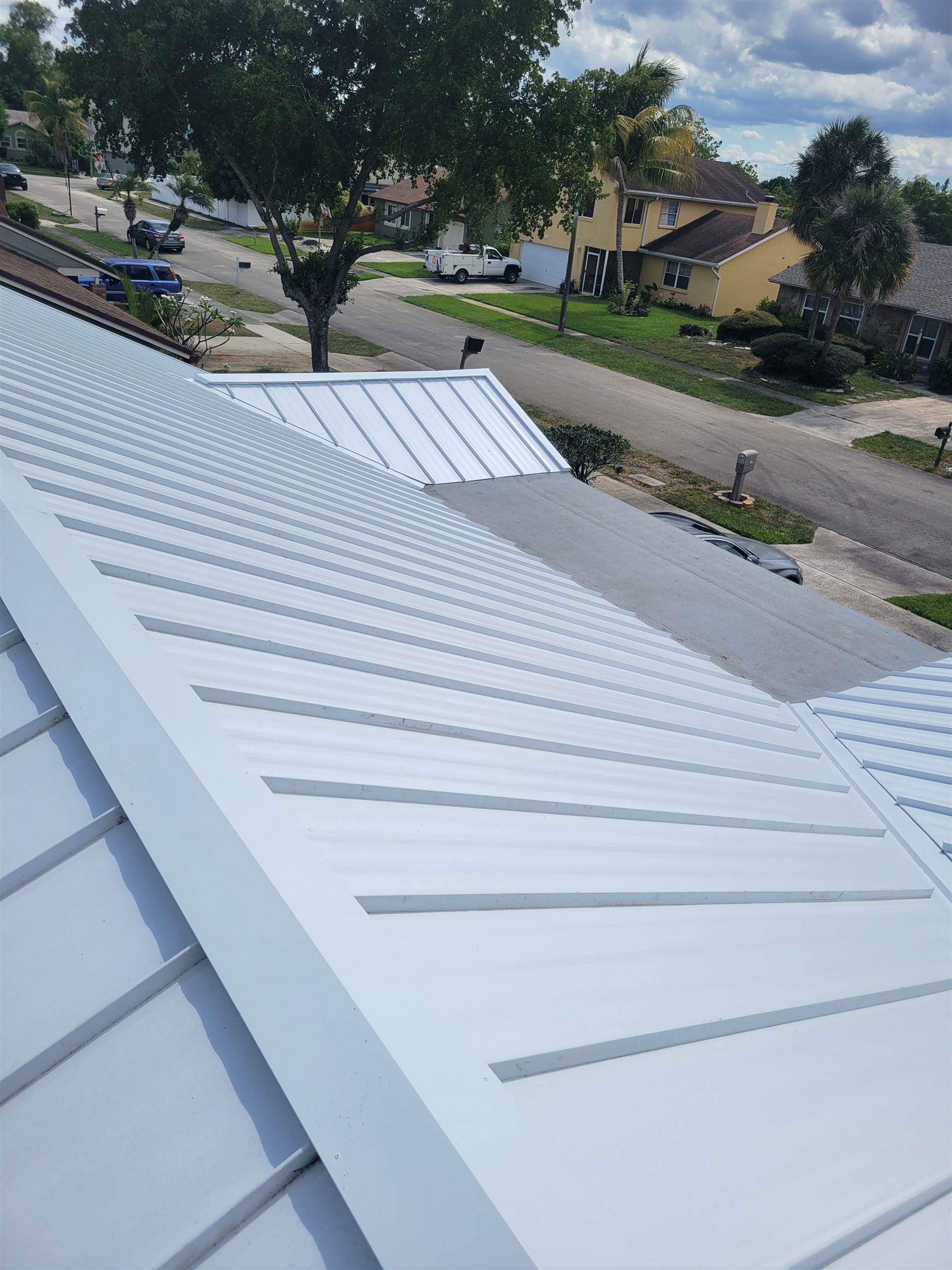 Standing Seam Metal & Flat Re-Roof using 1.5" Nail Strip 24ga Solar White Kynar Coated Standing Seam Metal Panels by Morton Roofing, Inc.