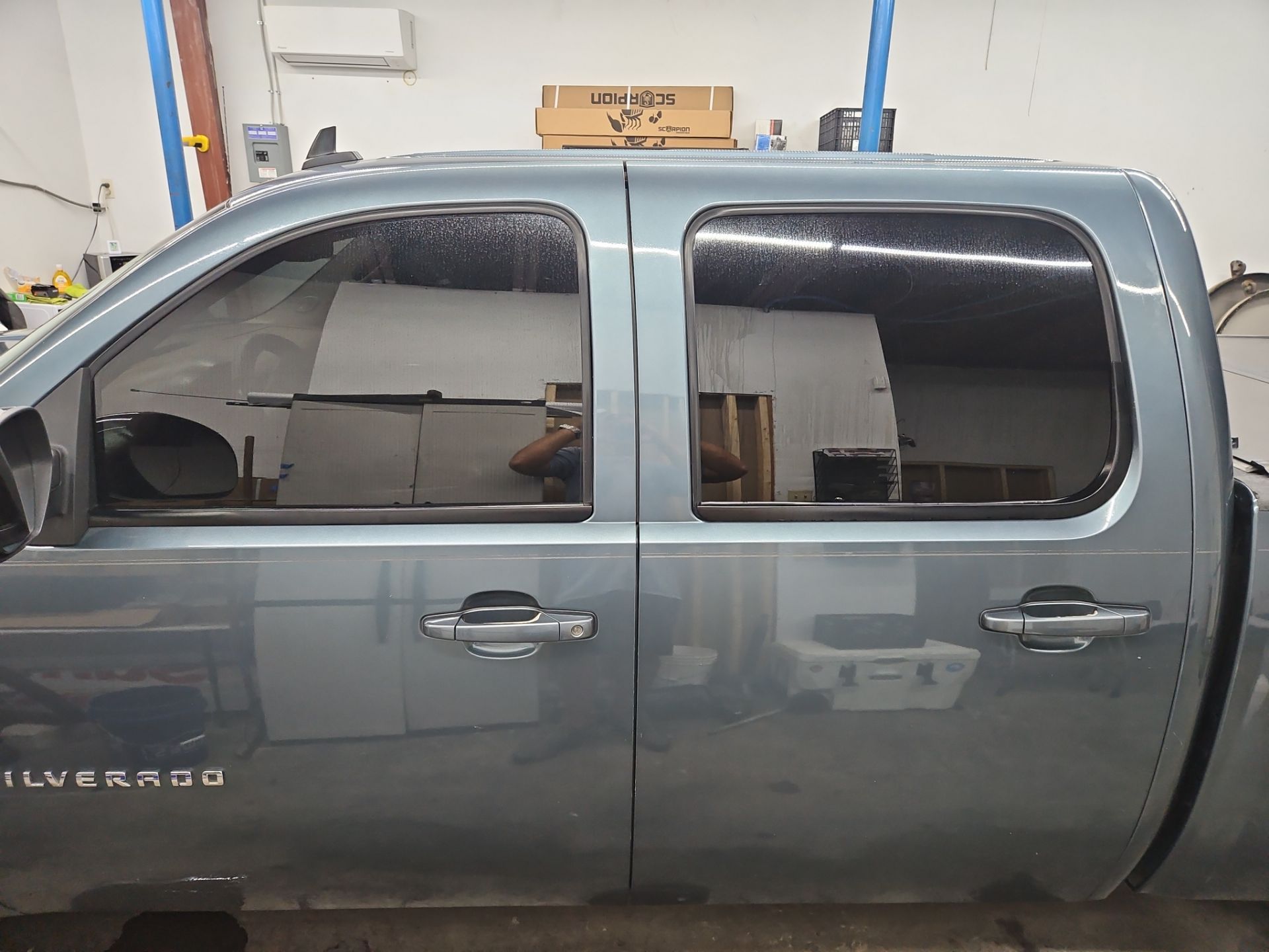 the service being done is window tinting for a truck which has dark tinted windows for enhanced privacy and UV protection the clean professional finish indicates high quality application and the vehicle is likely being prepared for improved aesthetics and comfort