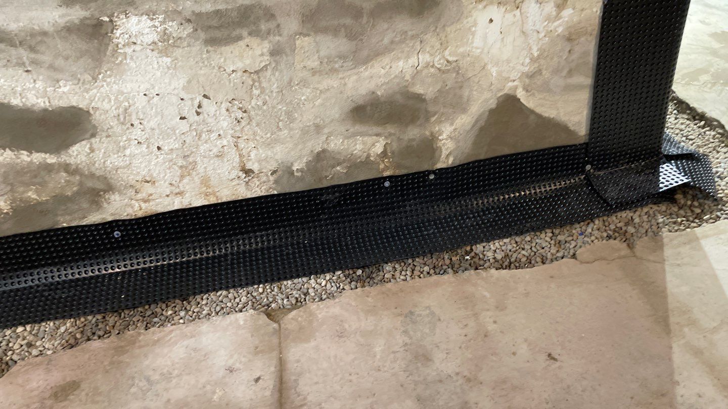 Drain Tile, Window Wells & Buried Discharge in Minneapolis by Waterproofing Northeast