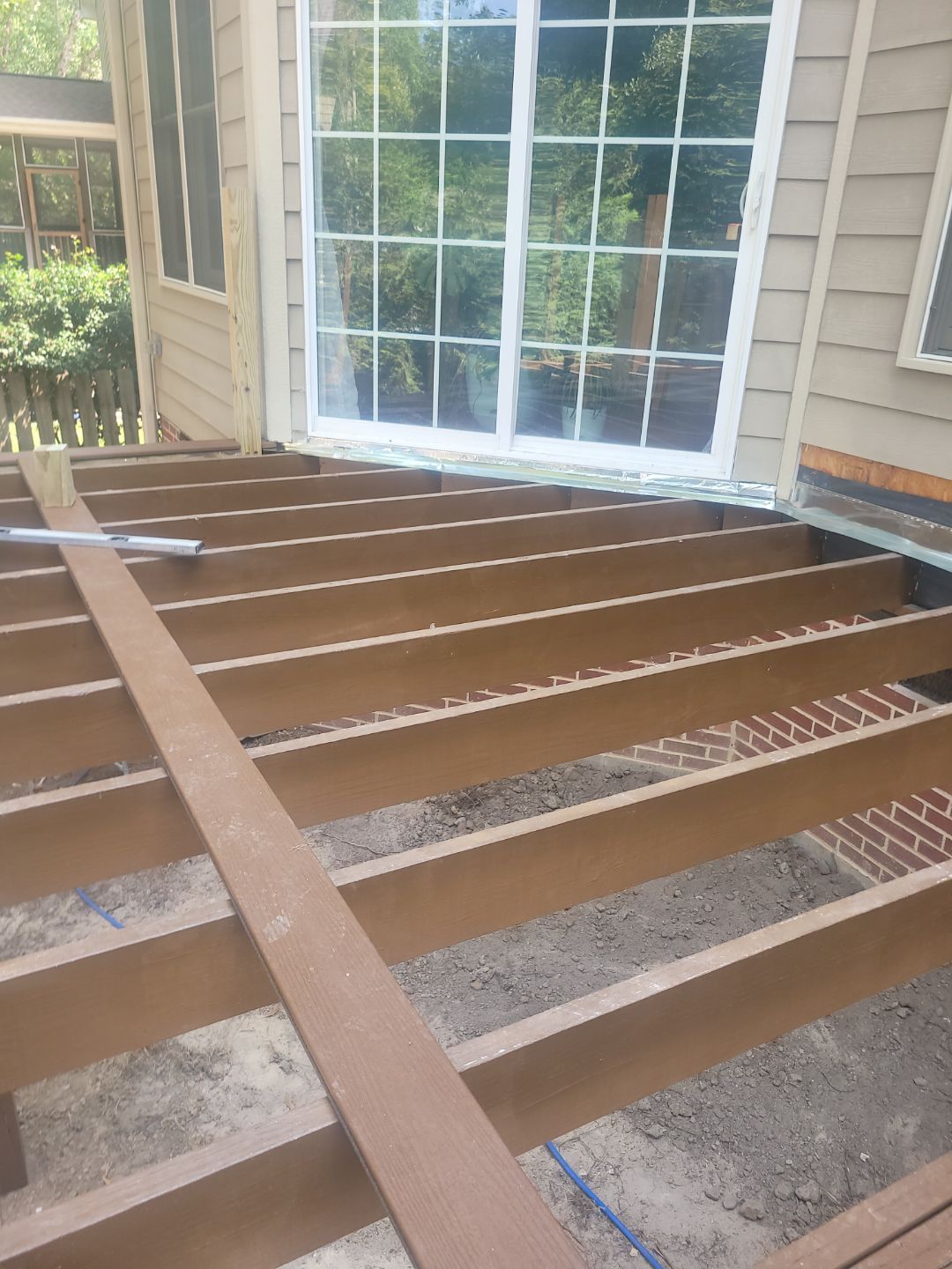 Fuquay-Varina Outdoor Upgrade – Composite Deck & Paved Landing by Elite Remodeling and Design LLC