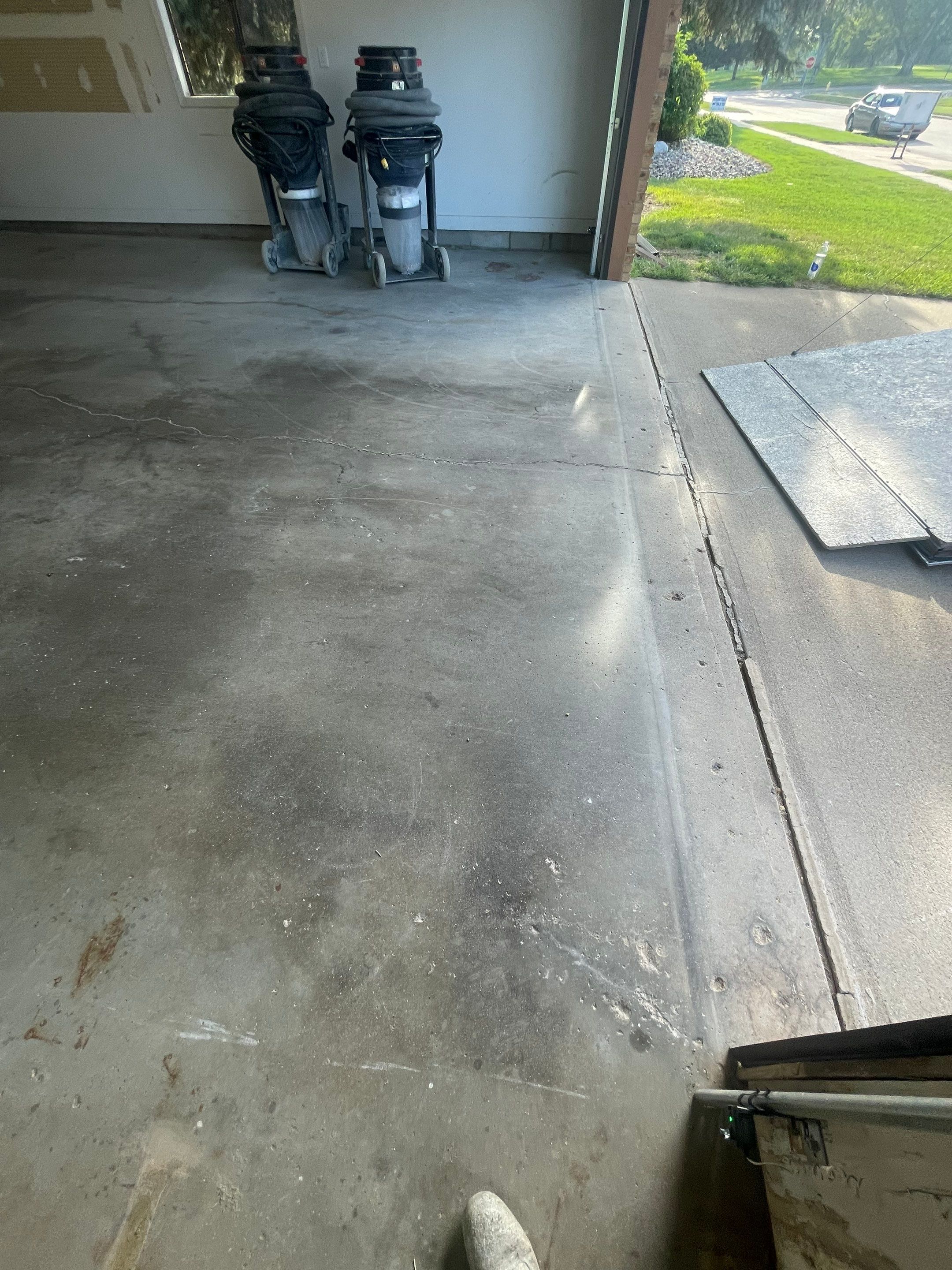 Grey Speckled Concrete Coating for Residential Garage in Yankton by Select Painting, Coatings & Garage Cabinets