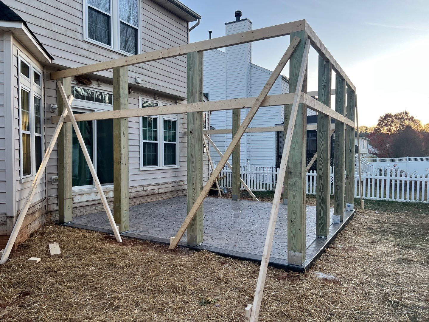 Custom Screened-In Porch with Stamped Concrete Patio in Warrenton by Jakari Restoration & Construction LLC