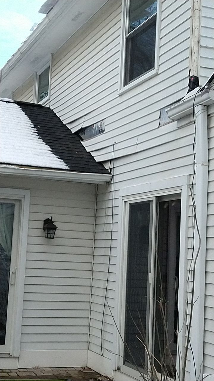 James Hardie Siding  using James Hardie Board and Batten, White by Absolute Roofing and Construction